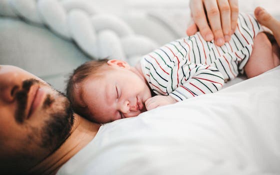 Baby sleeping on father's chest