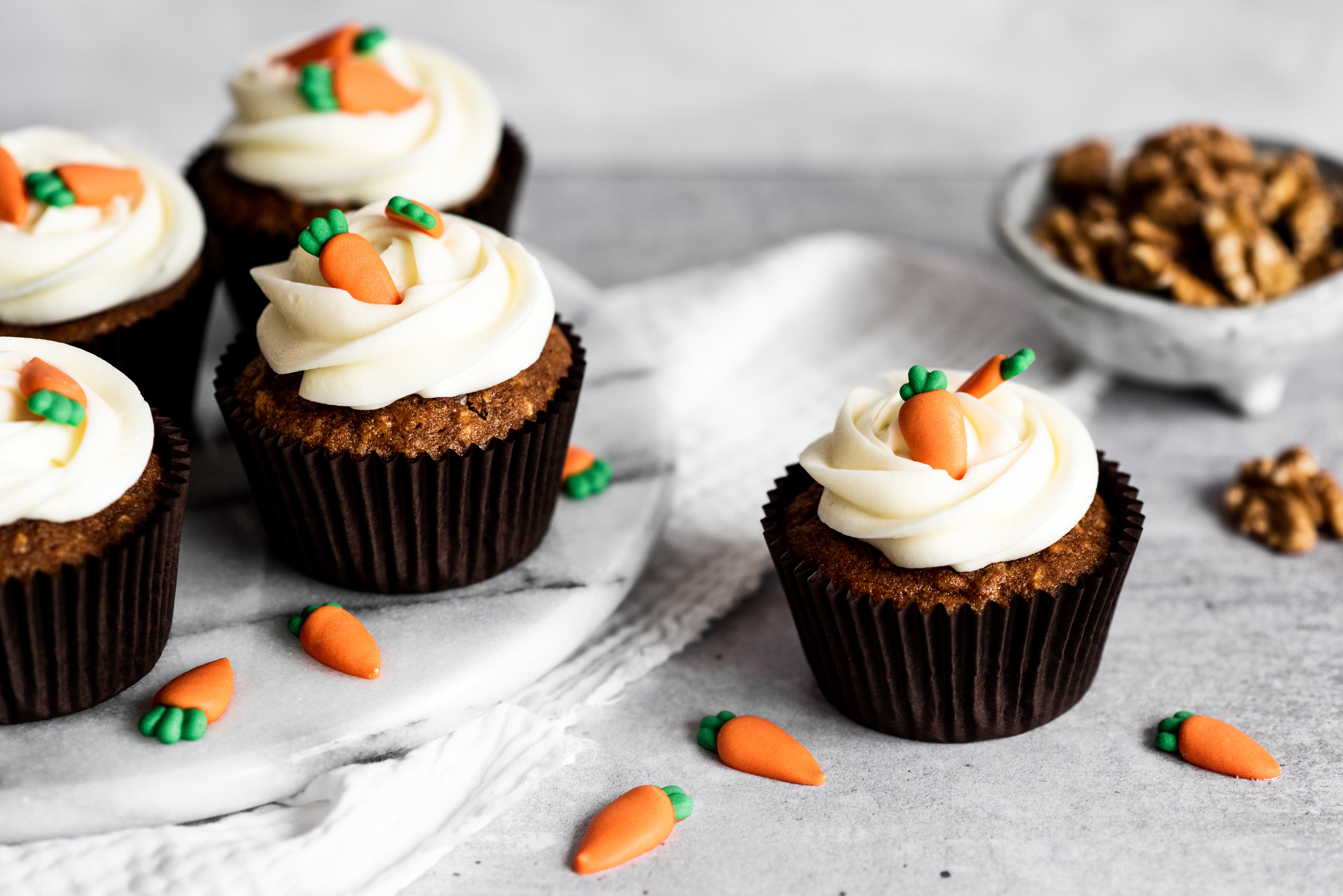 Carrot cake cupcakes with cream cheese icing and carrot decorations