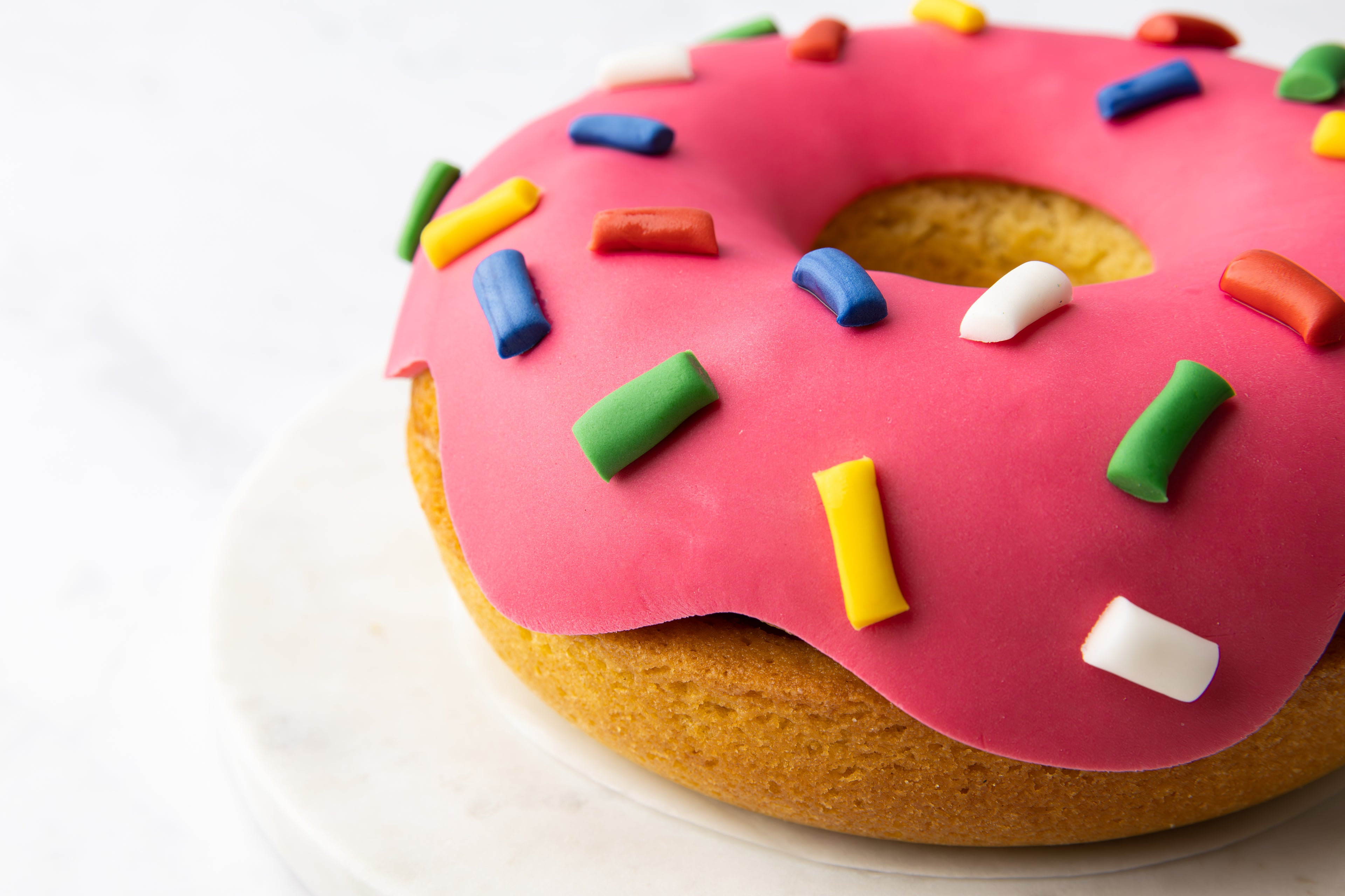 Cake shaped like a doughnut with pink icing