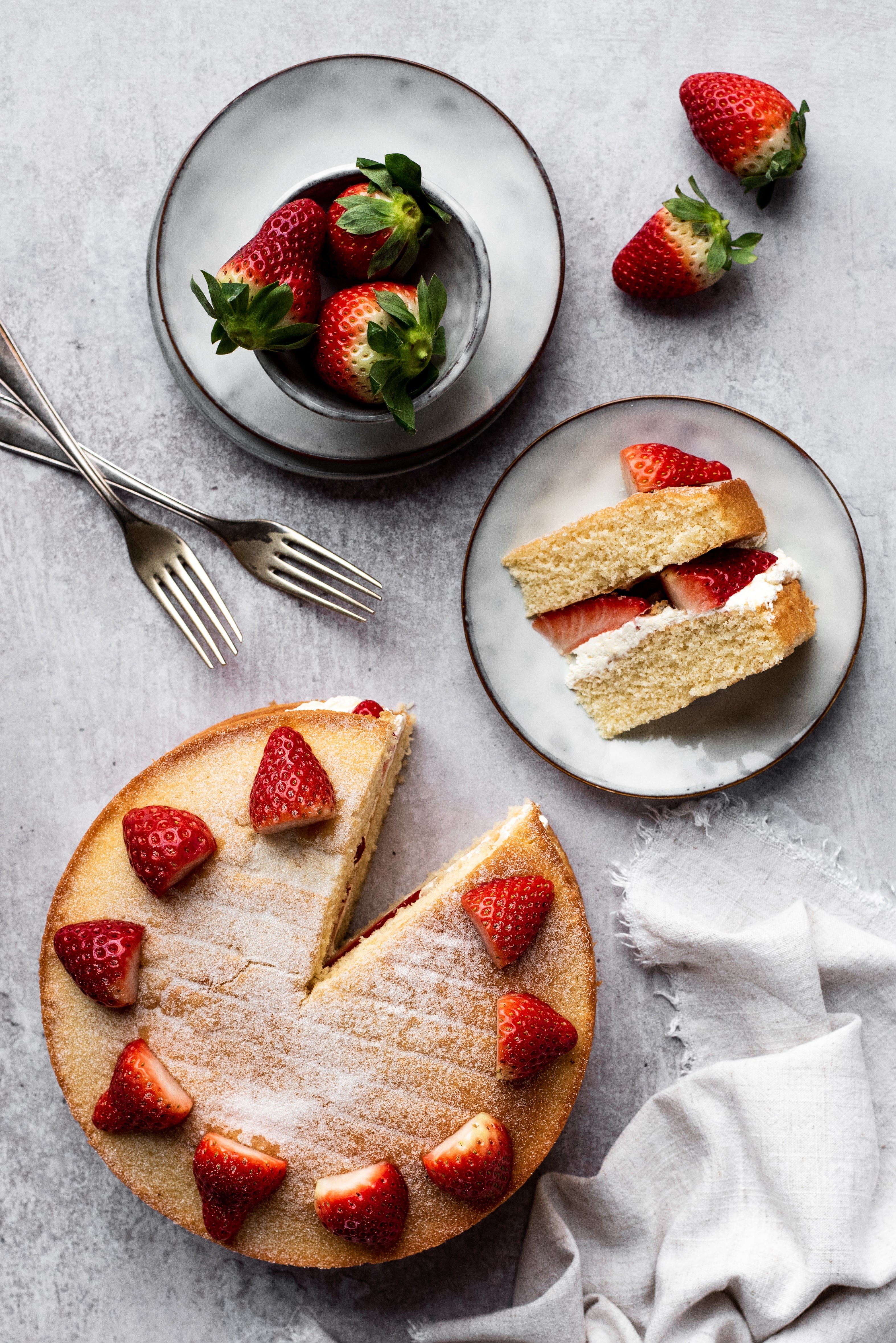 strawberries on top of a sponge cake