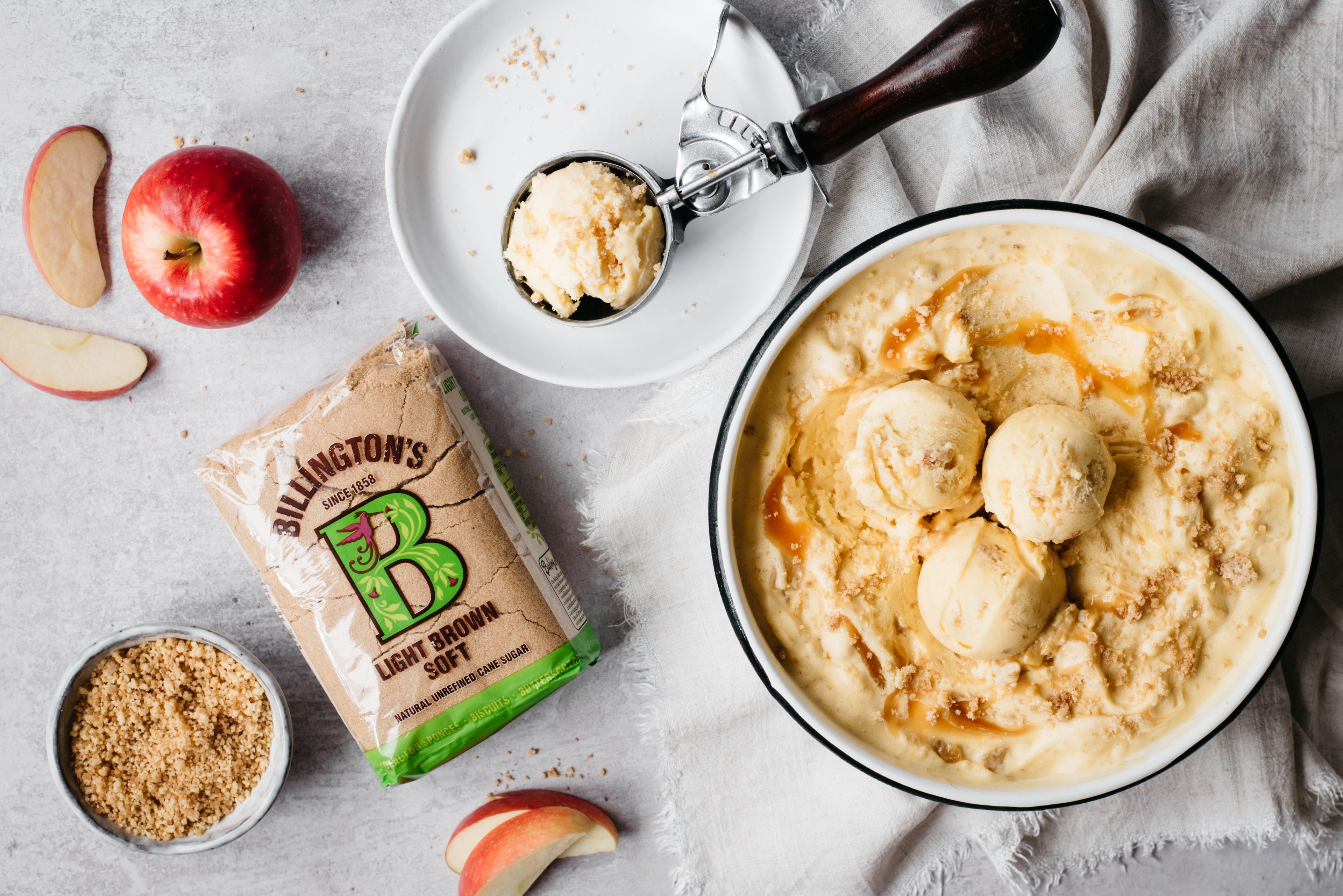 Bowl of ice cream, apple and slices, brown sugar packet