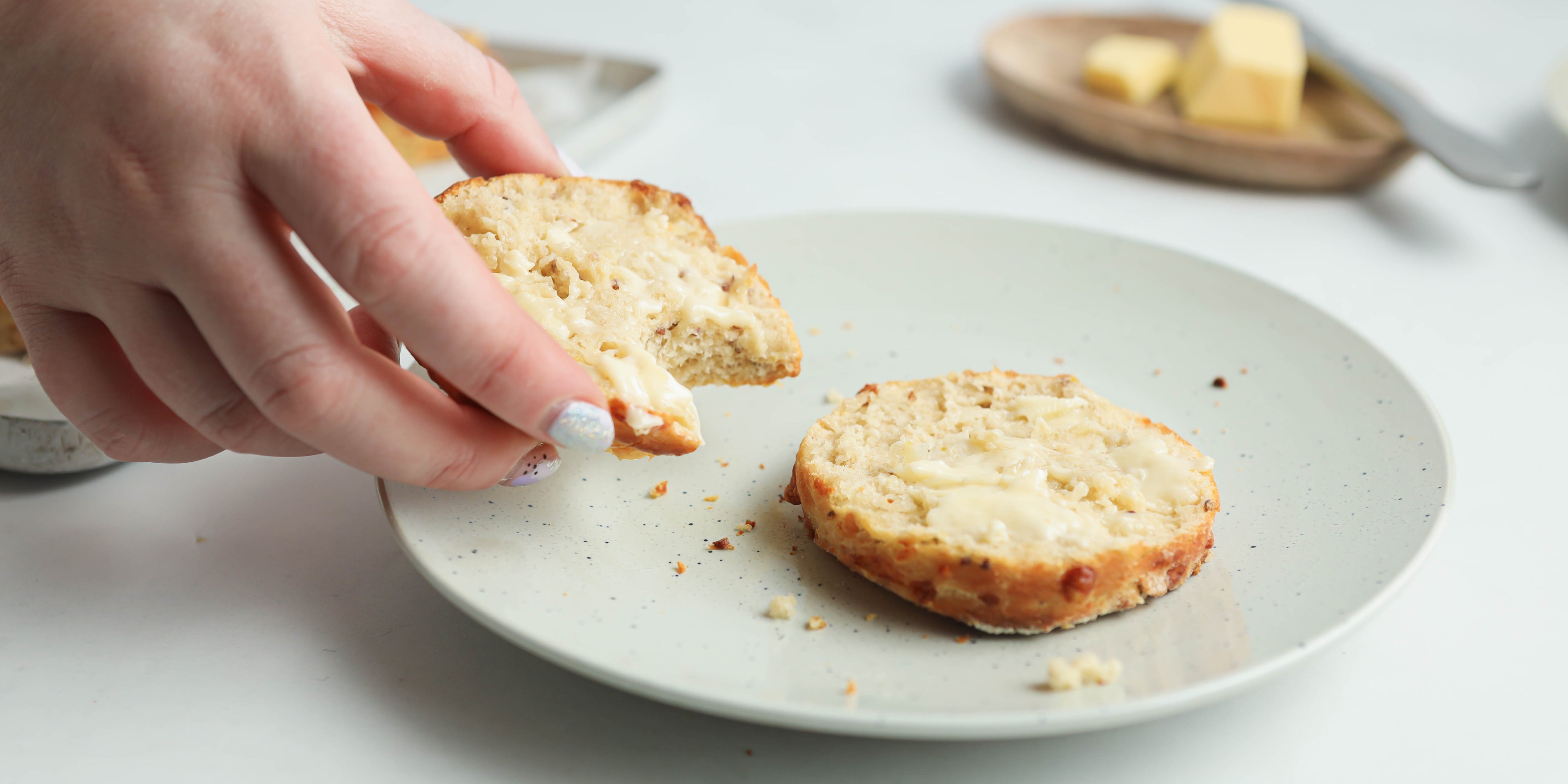 Close up of Cheese Scones with hand reaching for a bite 