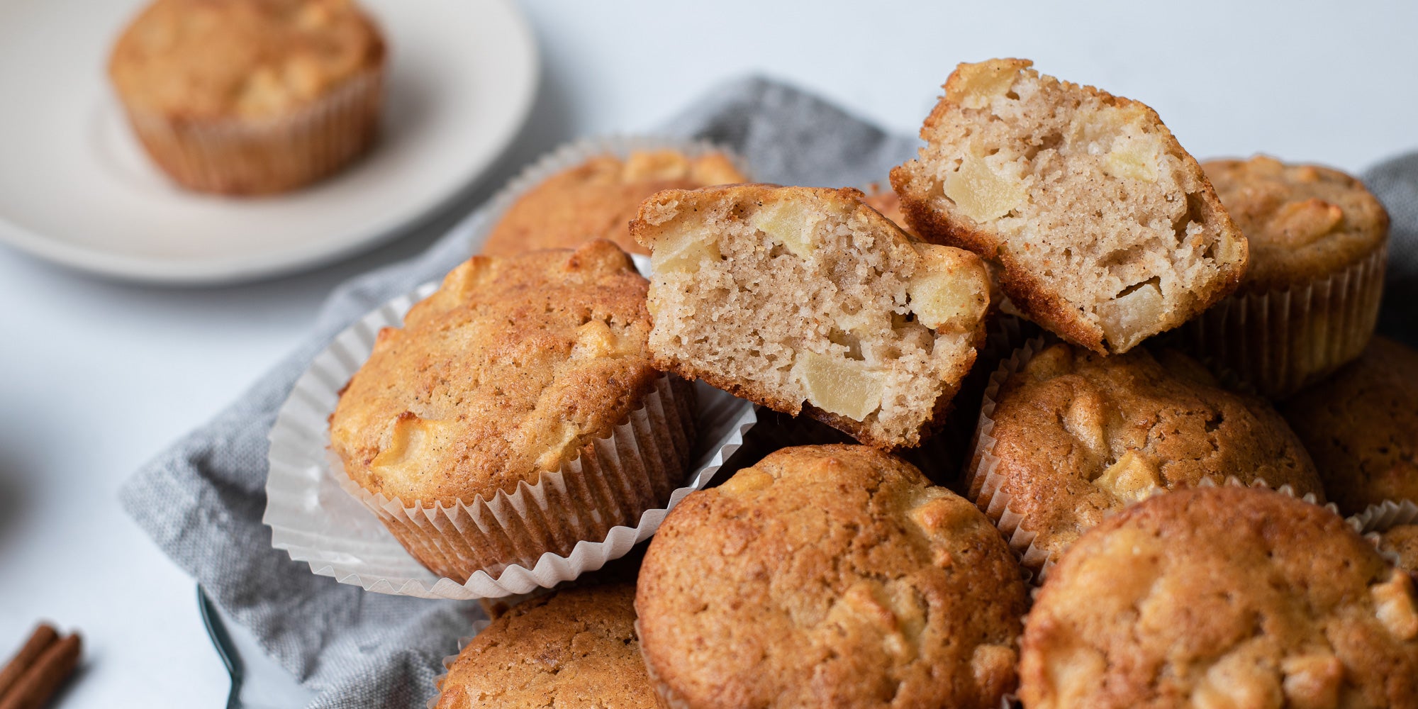A stack of Calorie Conscious Apple & Cinnamon Muffins, cut open showing the inside of the bake