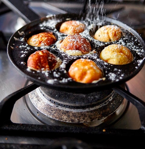 Aebleskiver Danish pancake balls cooking in an aebleskiver pan