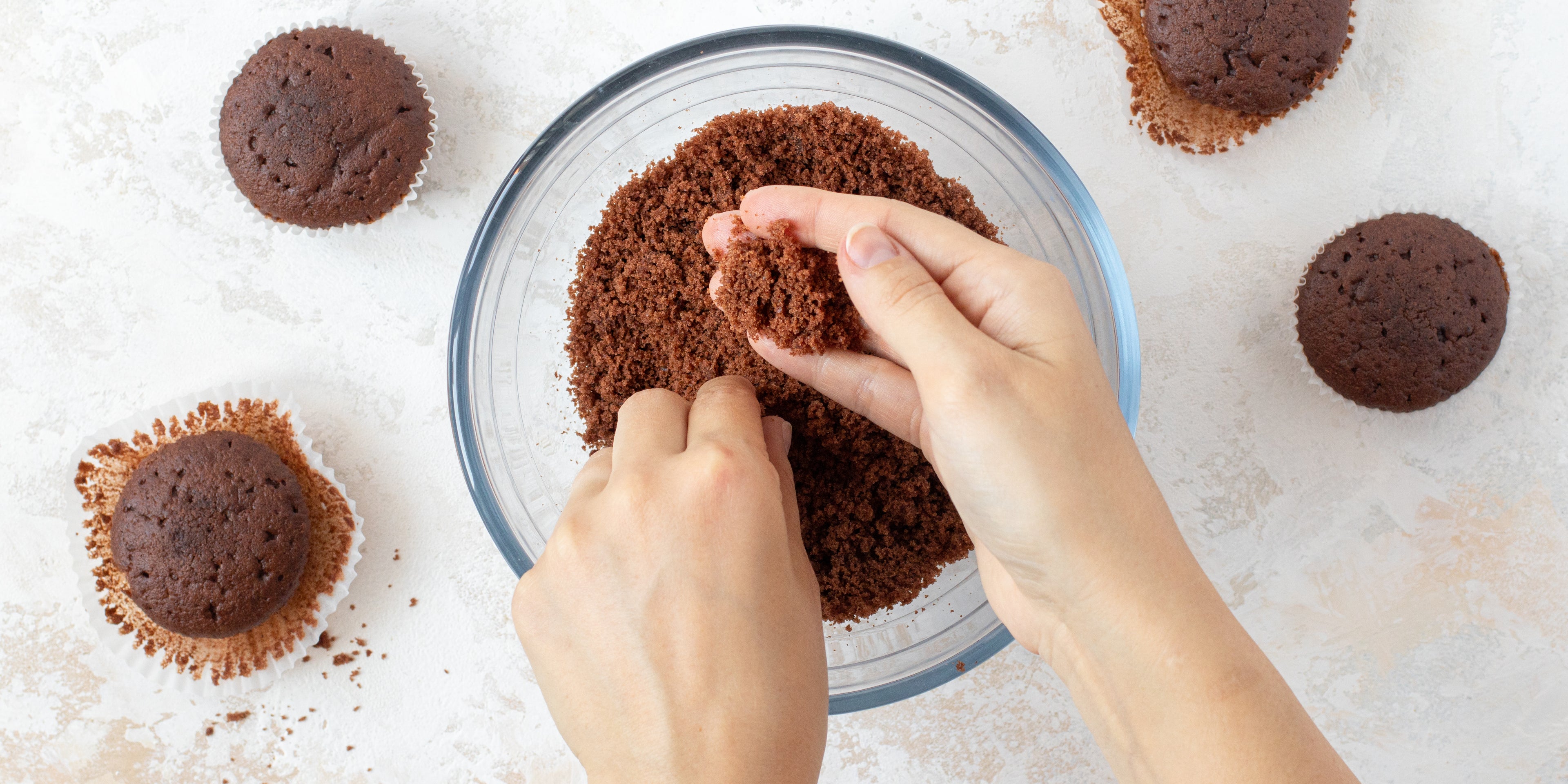 Lifestyle shot of Chocolate Cake Pops being made, with cake being rolled into a ball with a hands