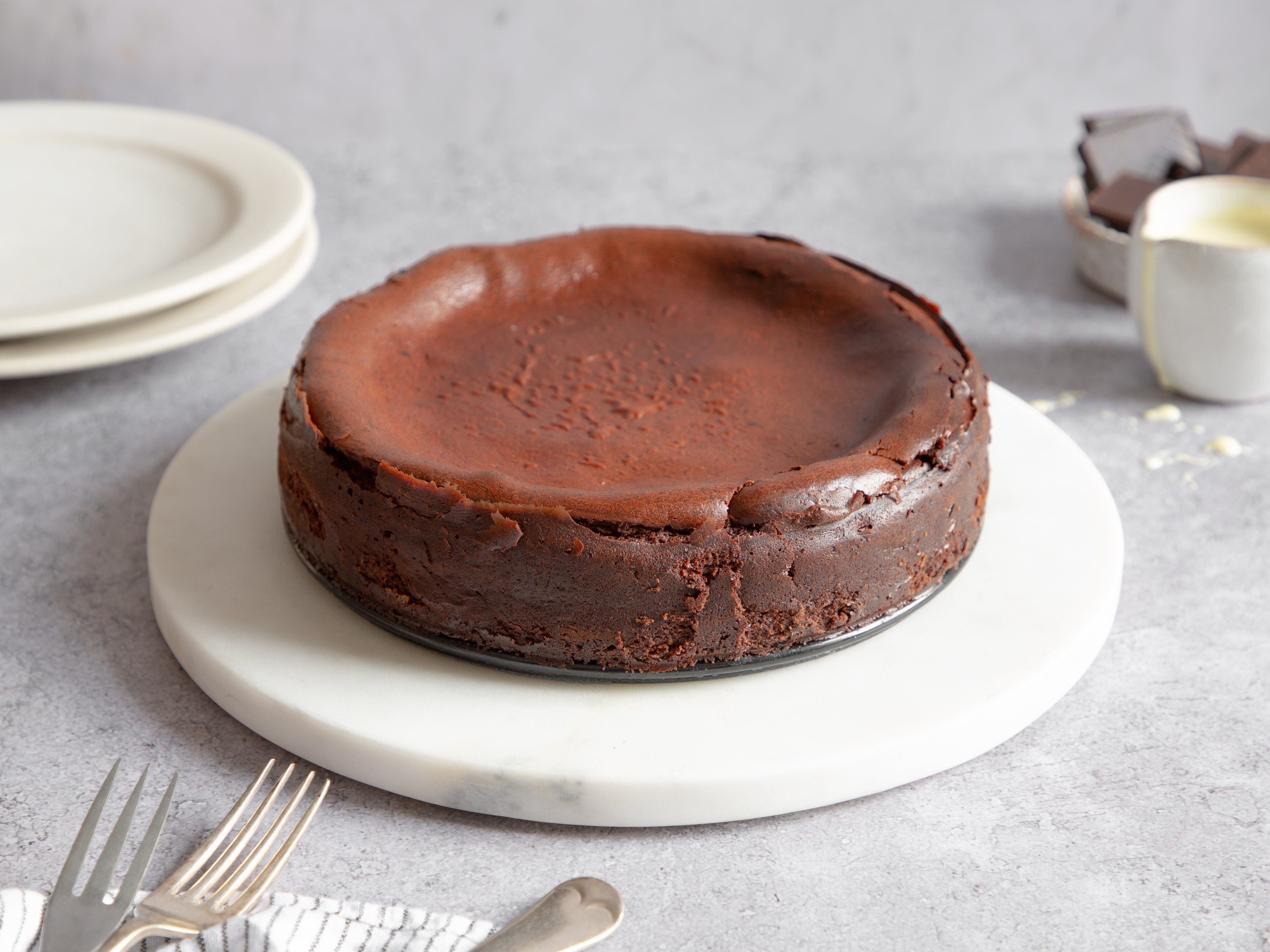 Chocolate Cheesecake on a marble board, ready to decorate