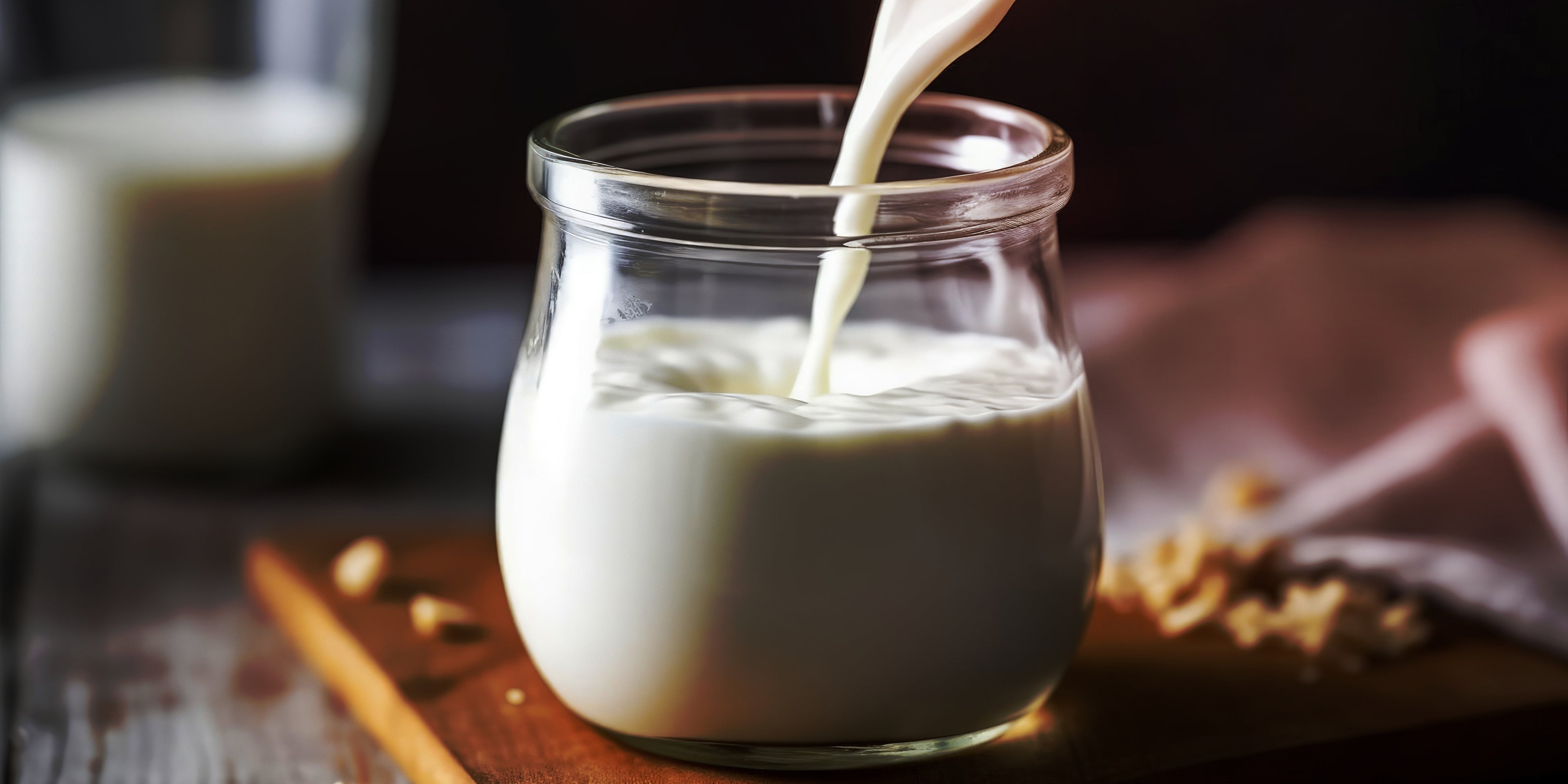 Pouring buttermilk into a glass jar