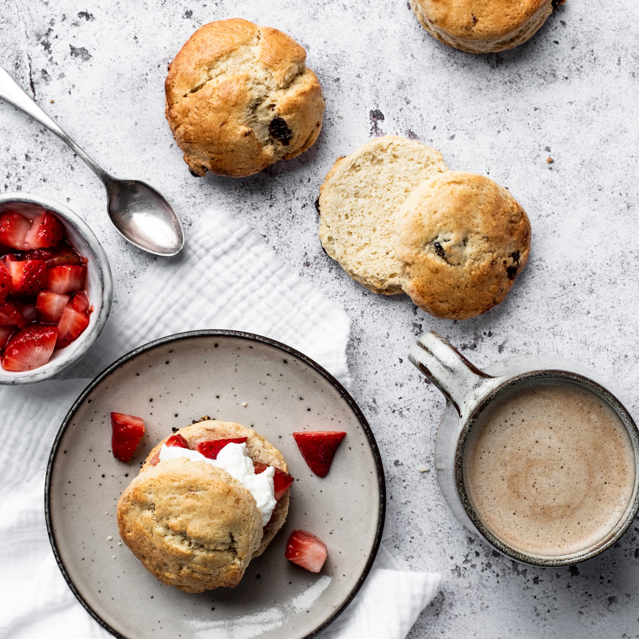 scone with strawberries and cream on a plate 