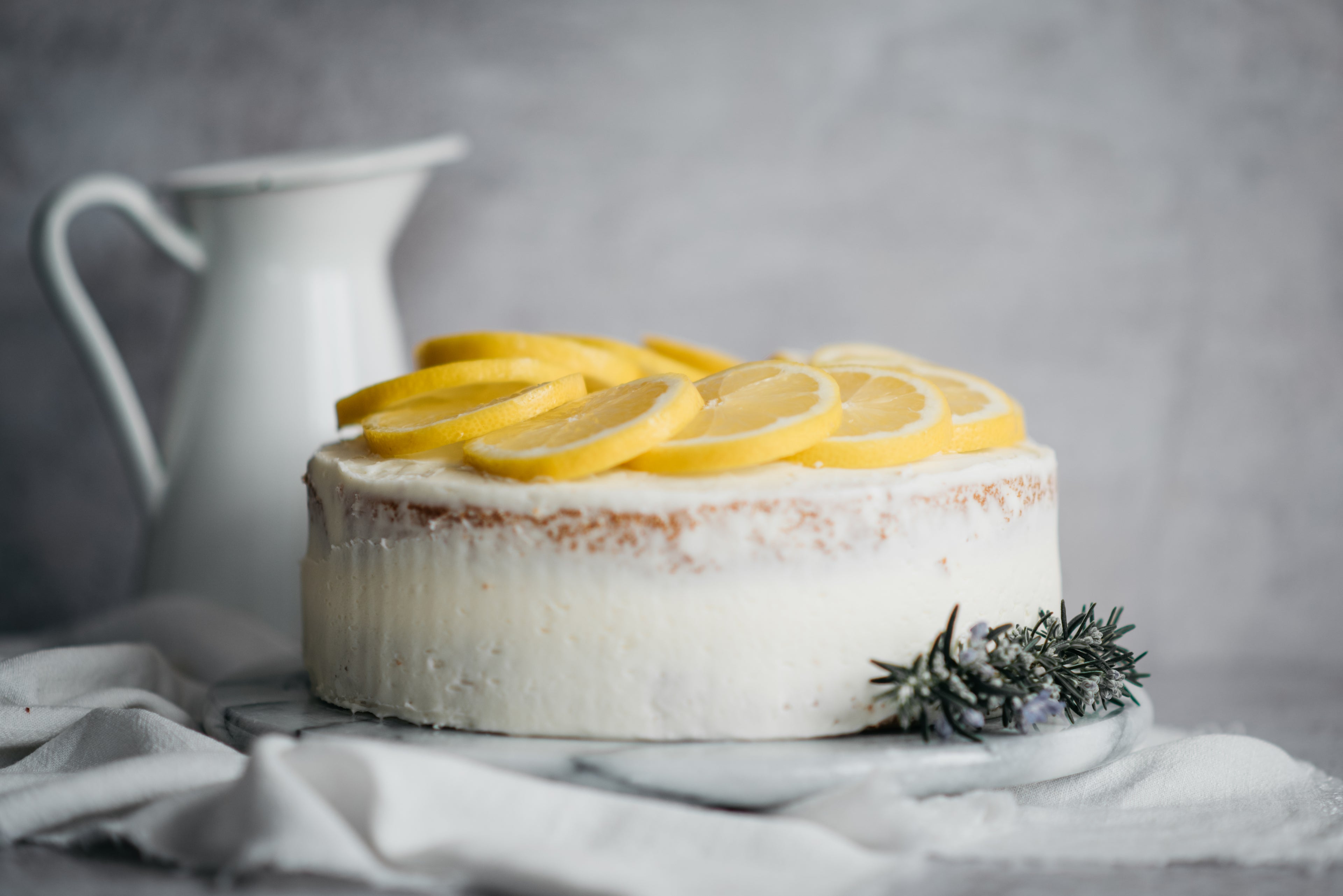 Close up view of Gluten Free Elderflower & Lemon Cake topped with sliced lemon