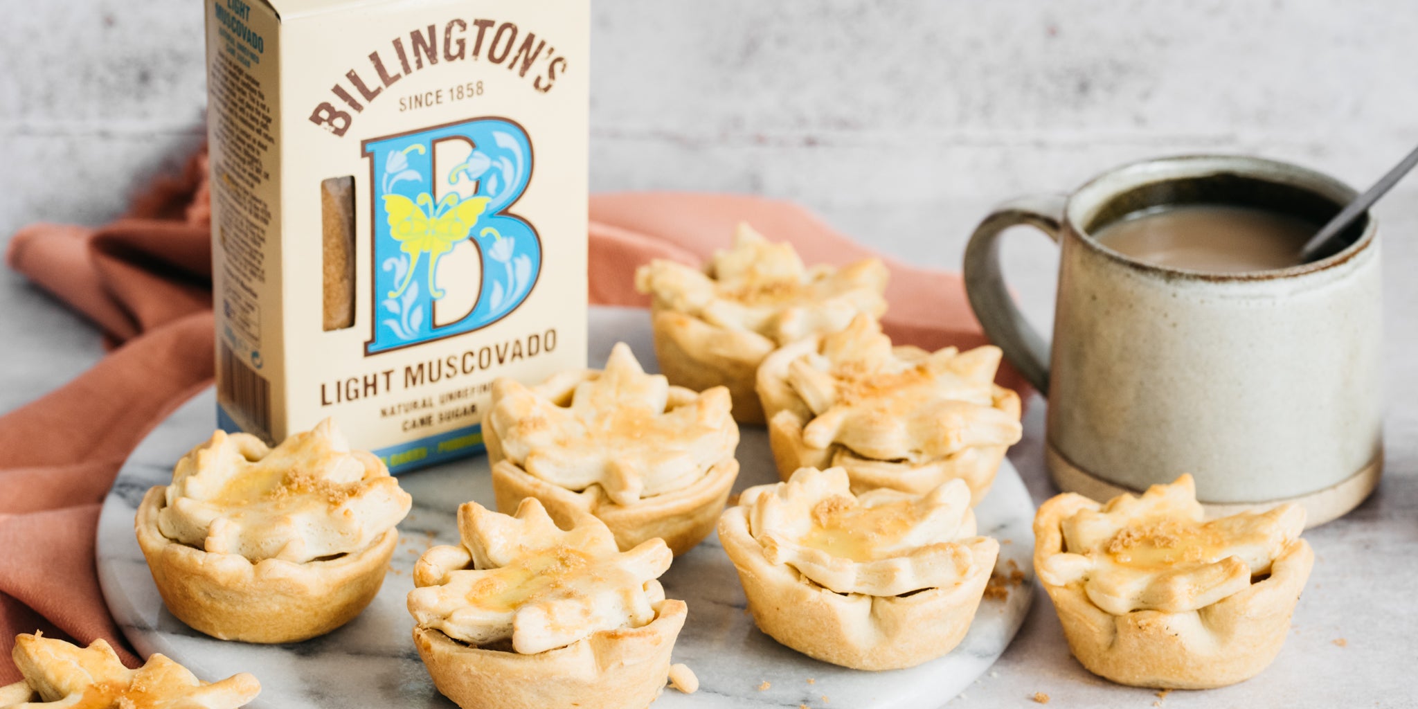 Pumpkin pies with sugar pack and coffee cup