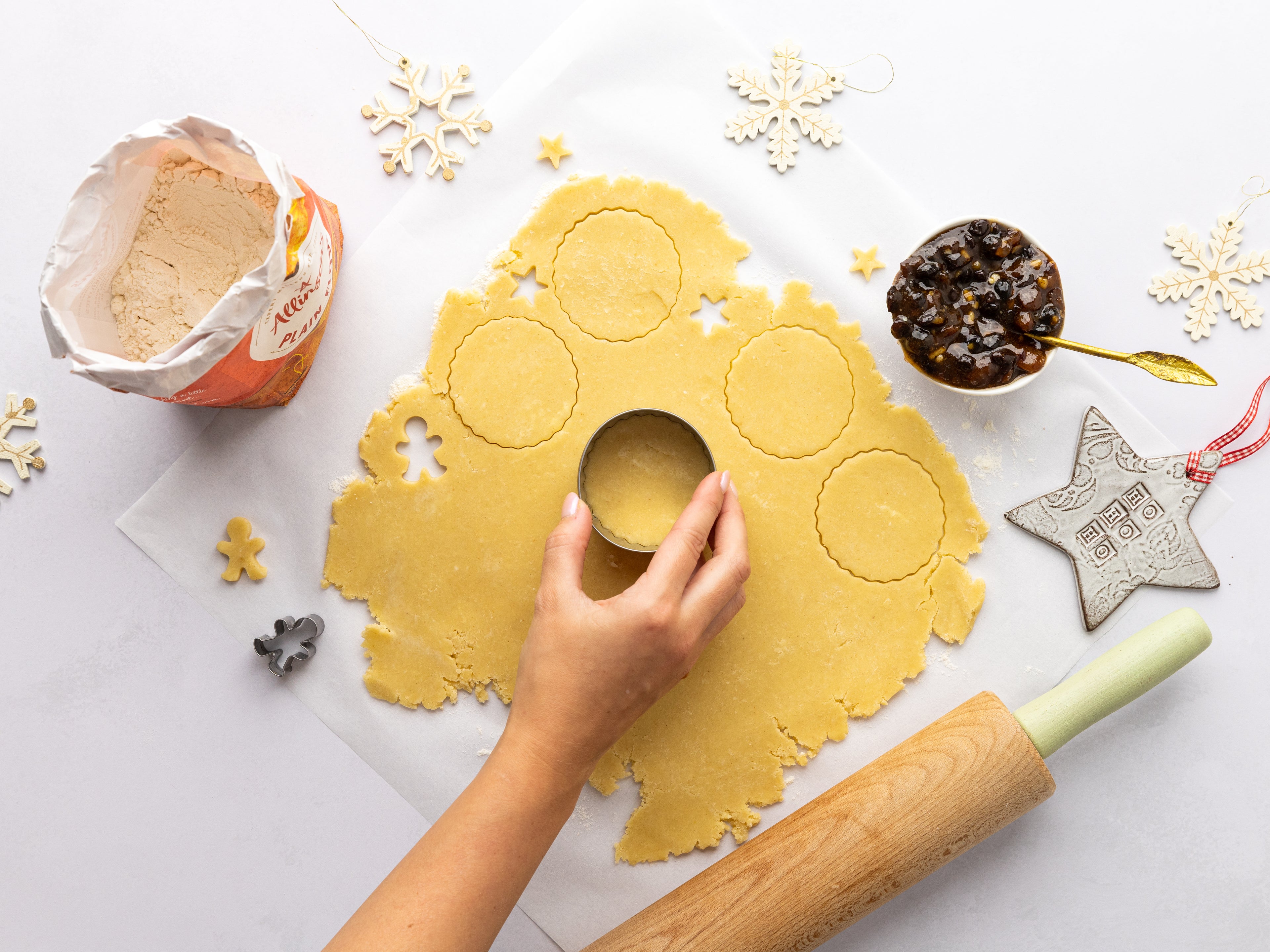 Hand cutting out circles from pastry with a cutter