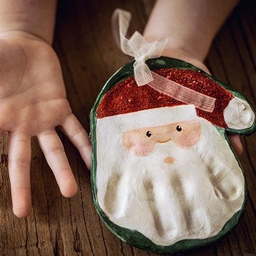 Hand print salt dough shape decorated to look like Santa