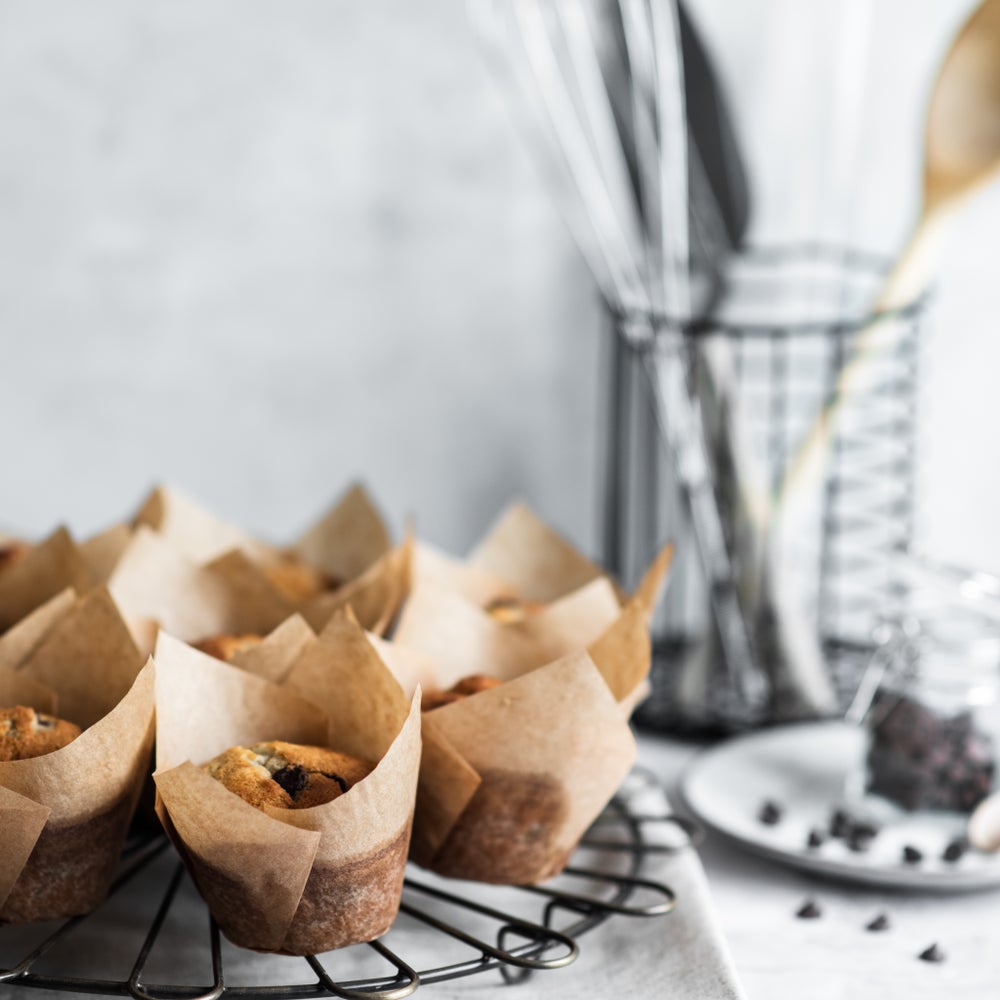 Set of banana and chocolate chip muffins on a wire cooling rack