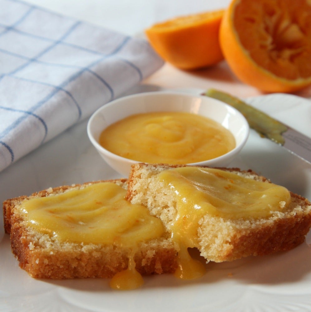 Slices of sponge cake topped with a thick layer of homemade orange curd