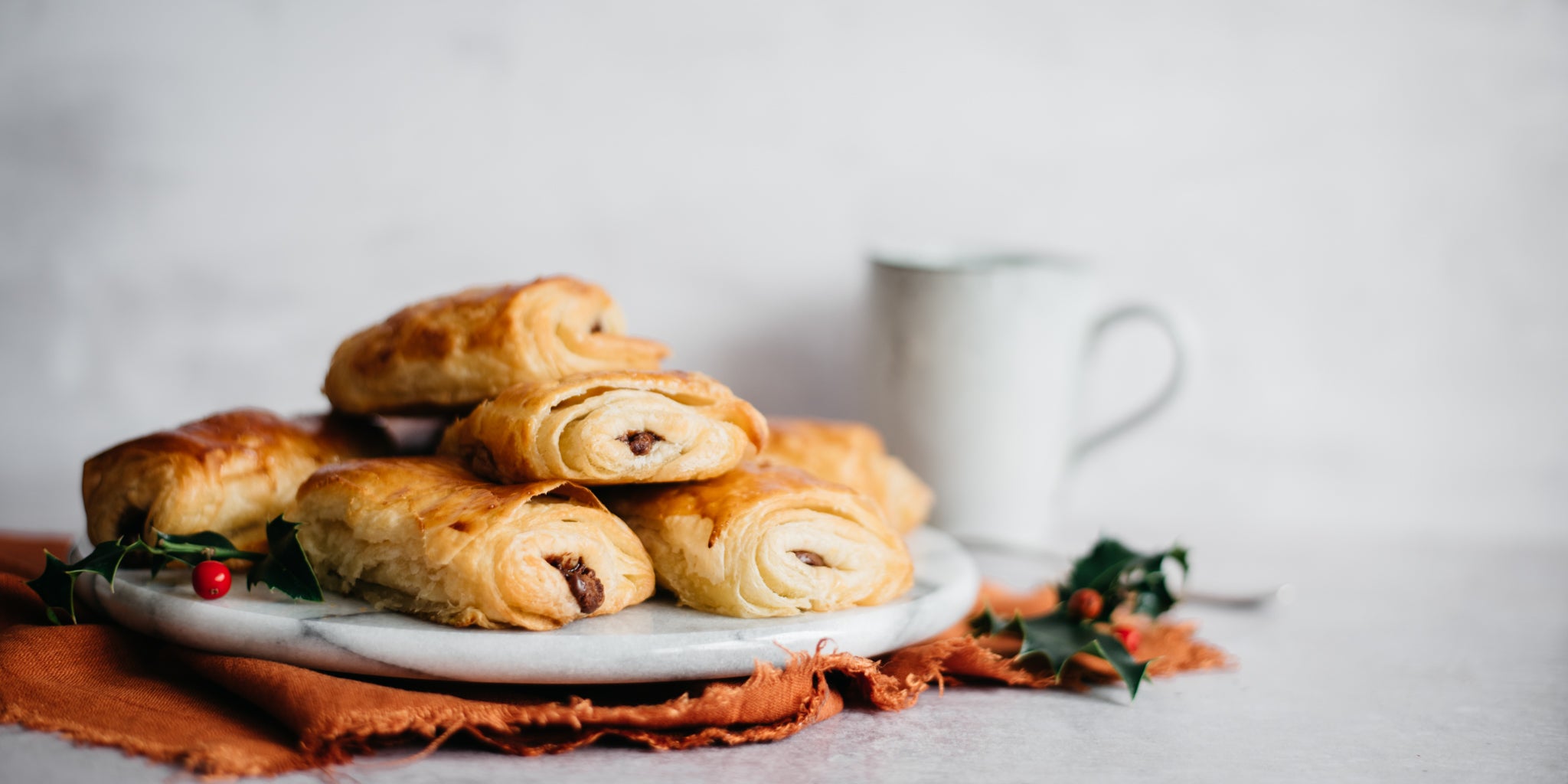 Side on image of a plate of terry's chocolate orange pain au chocolats