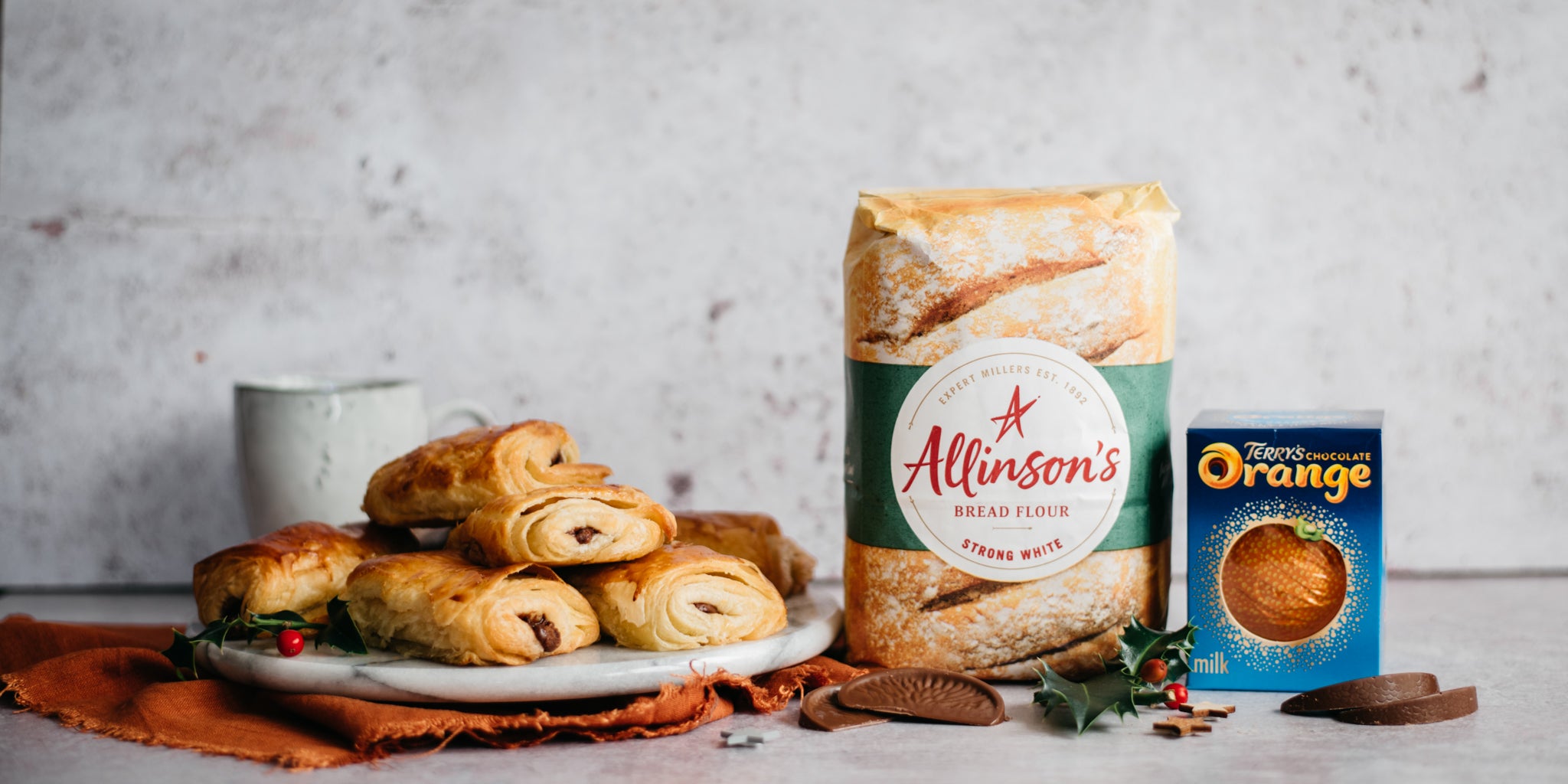 A plate of terrys chocolate orange pain au chocolat next to allinsons strong white bread flour and terrys chocolate orange