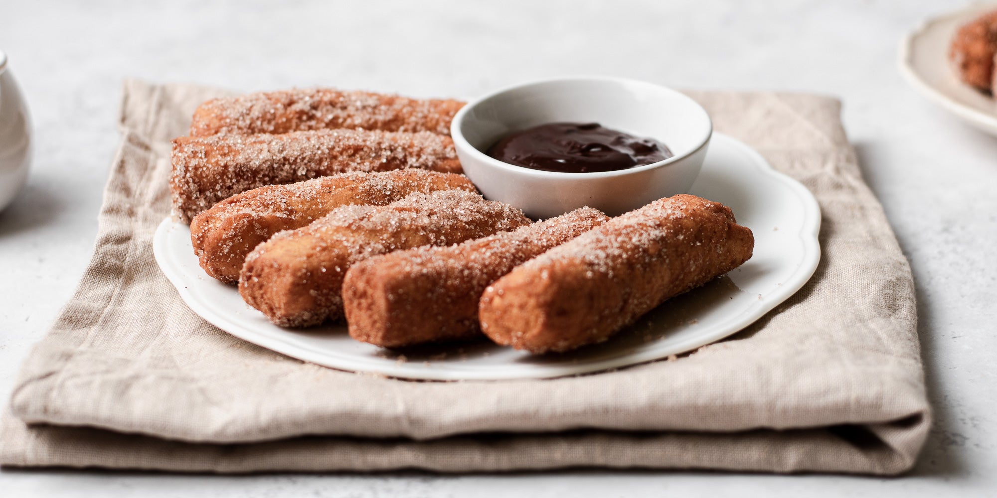Doughnut Sticks with Chocolate Dip on a plate