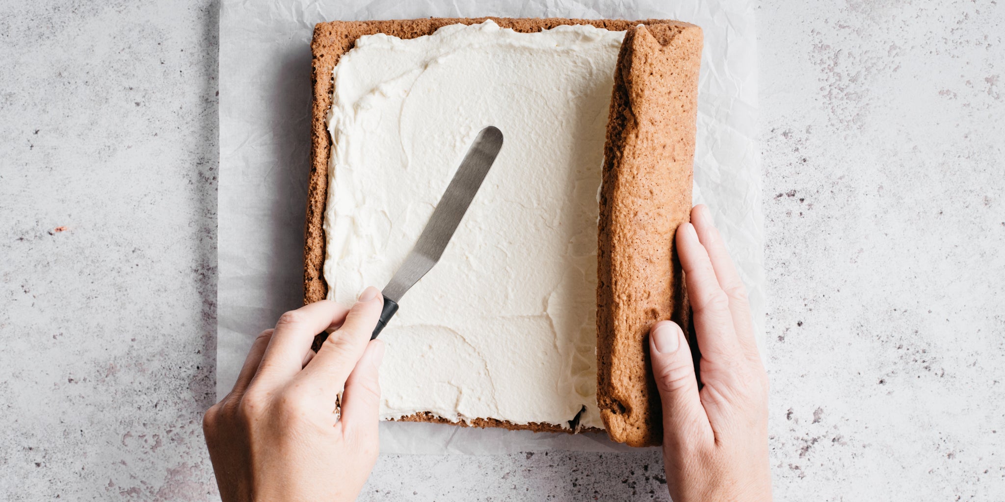 Yule log sponge being spread with buttercream