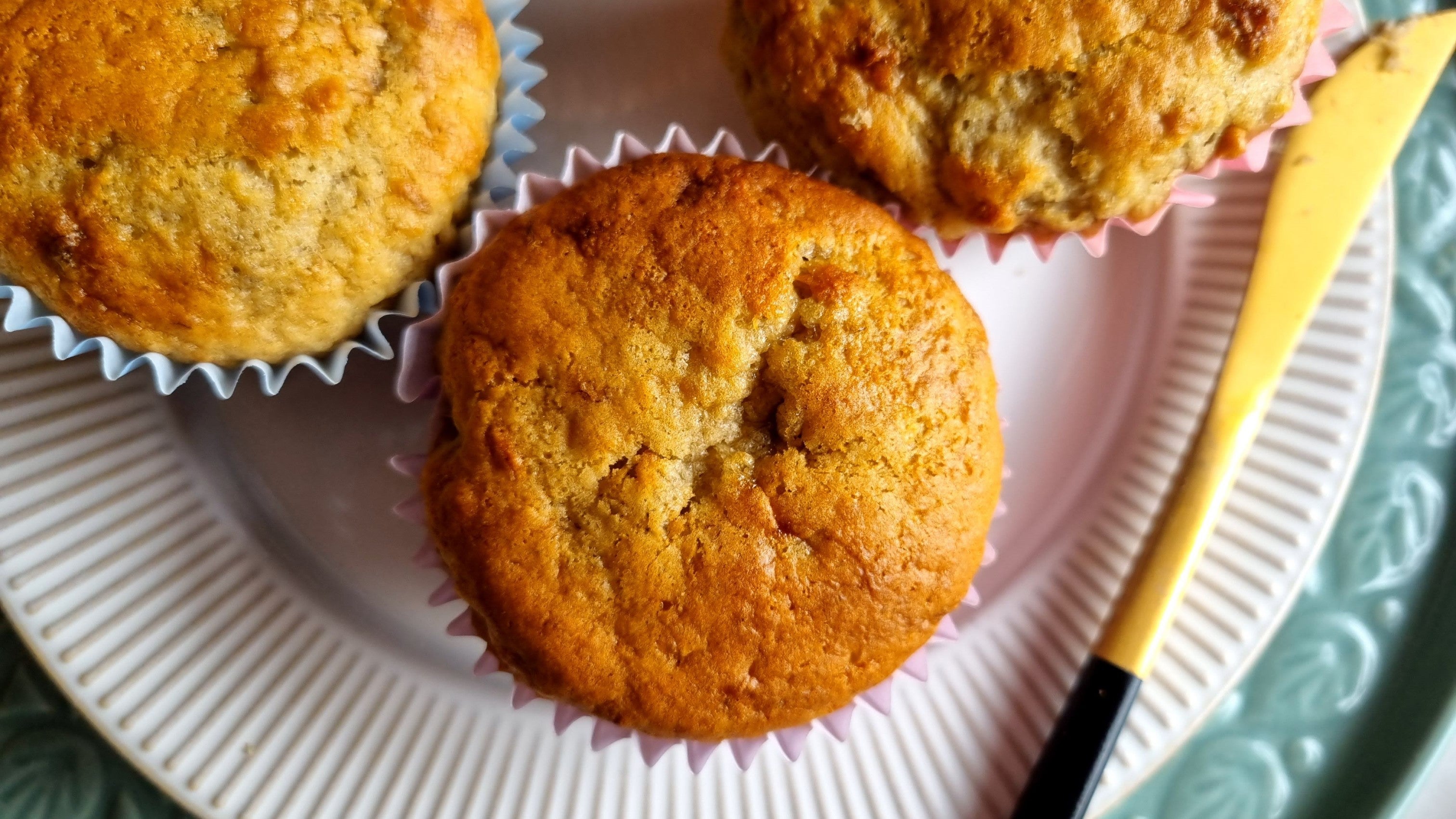 Top-down view of fresh banana muffins with golden tops