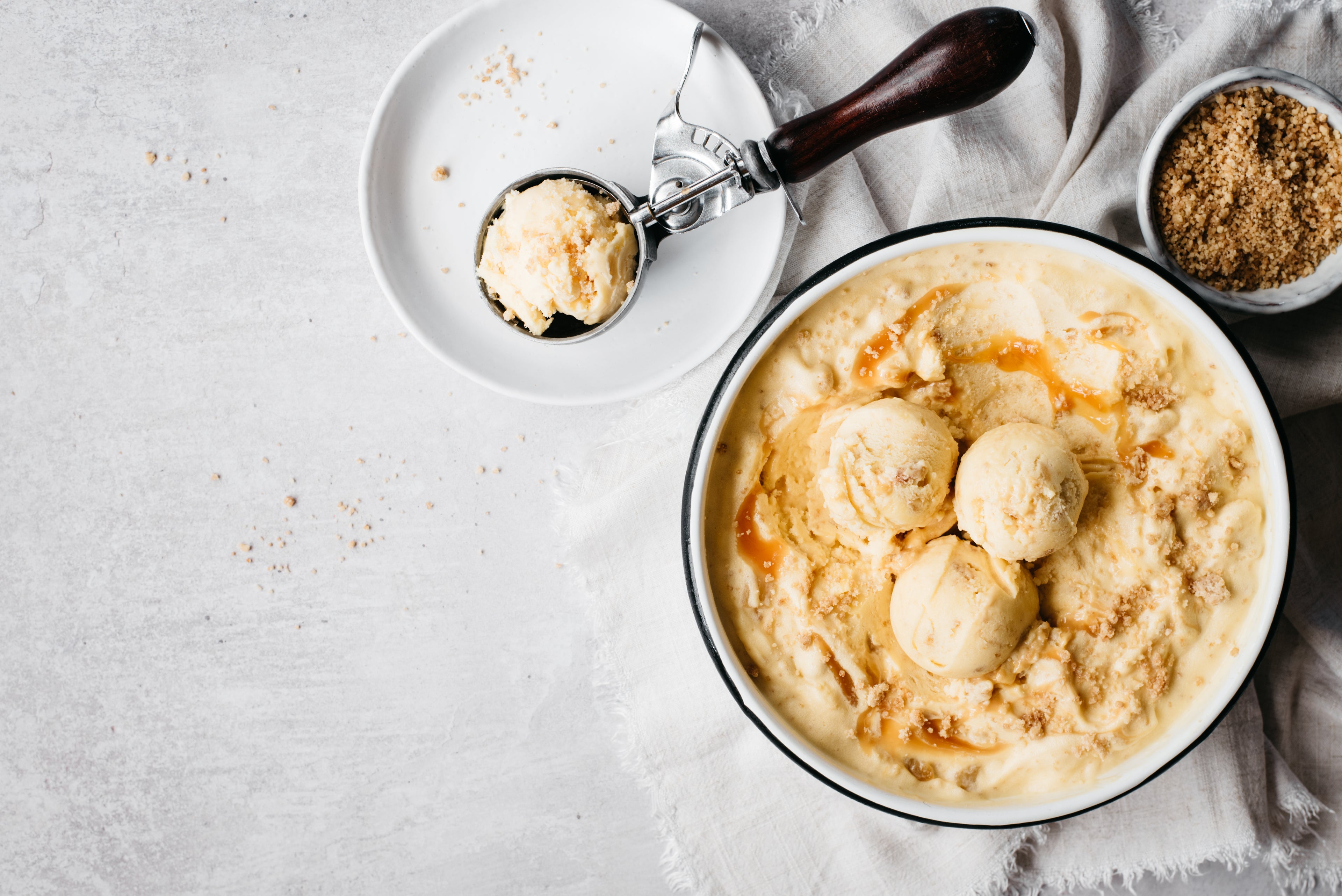 Bowl of ice cream with white bowl and ice cream scoop