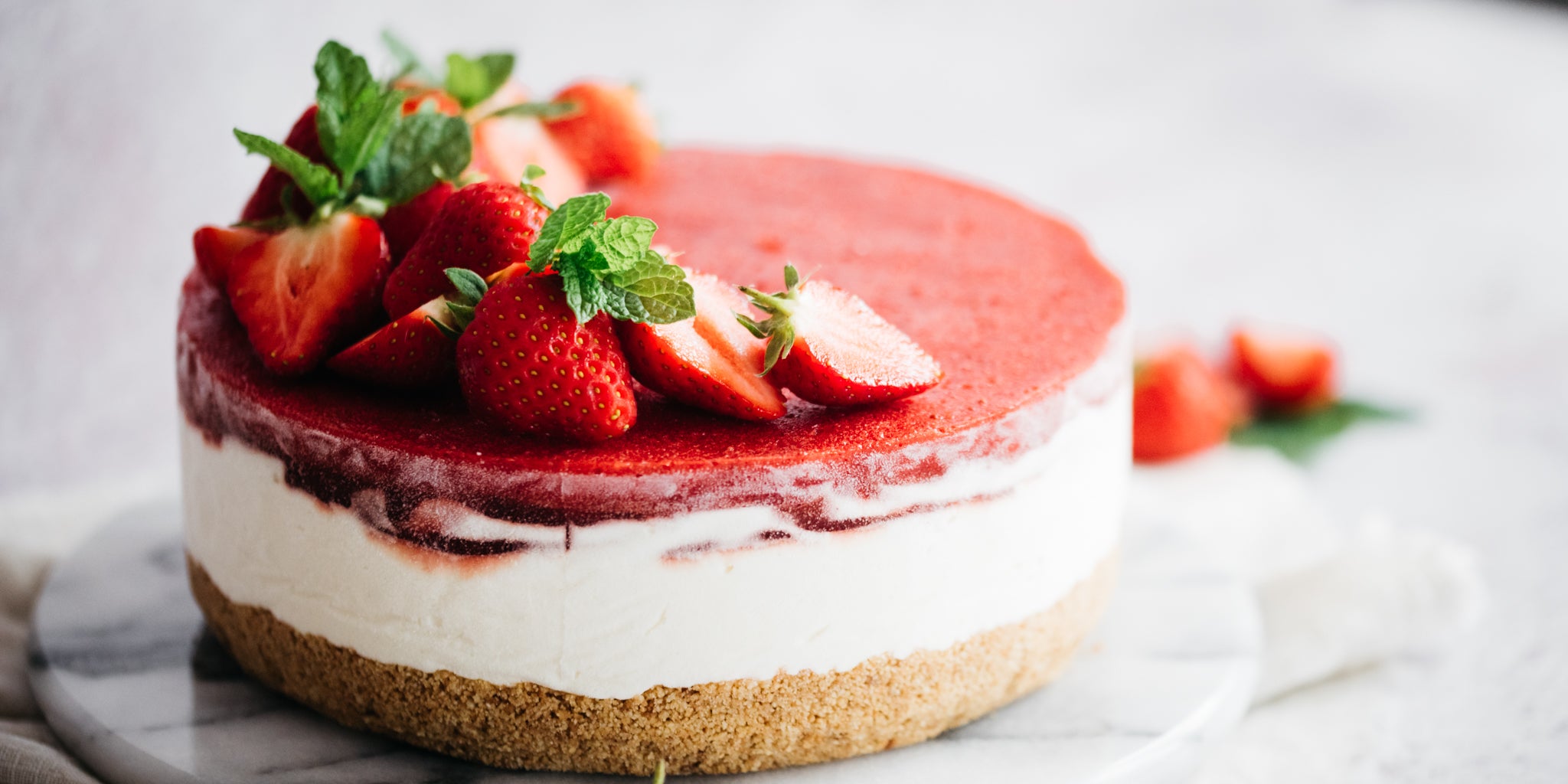 Strawberry cheesecake on a white marble plate