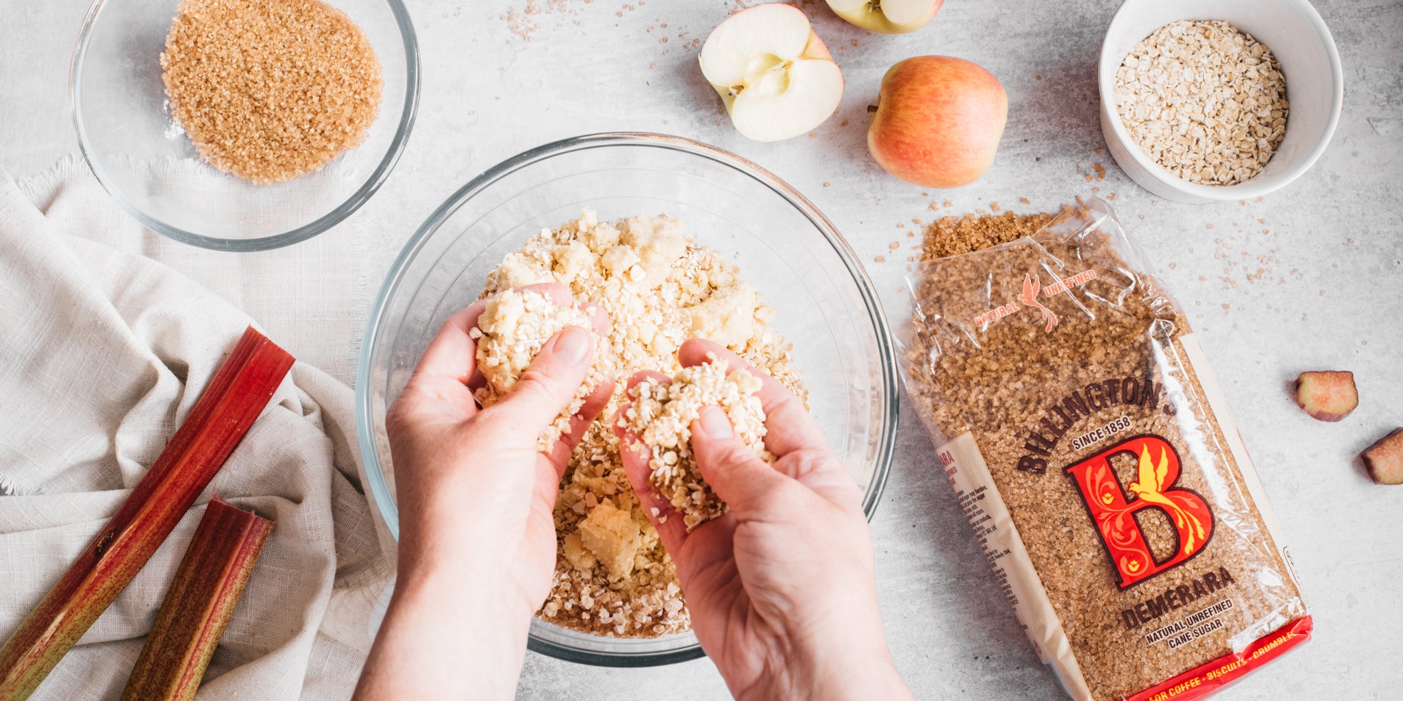 Hands rubbing in butter and flour in a bowl