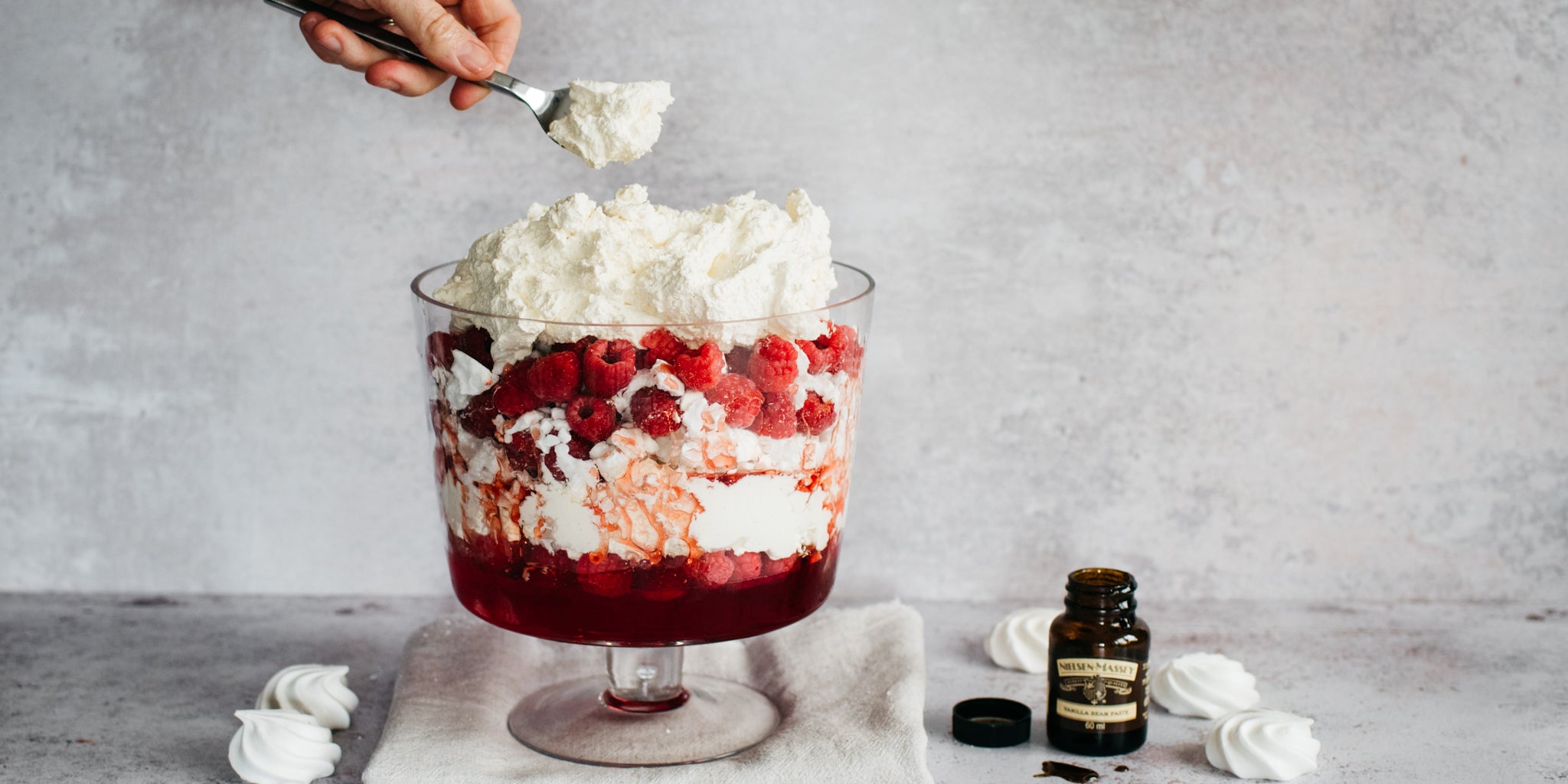 Eton Mess Trifle layered with layers of fresh vanilla cream, meringue and raspberry sauce. 