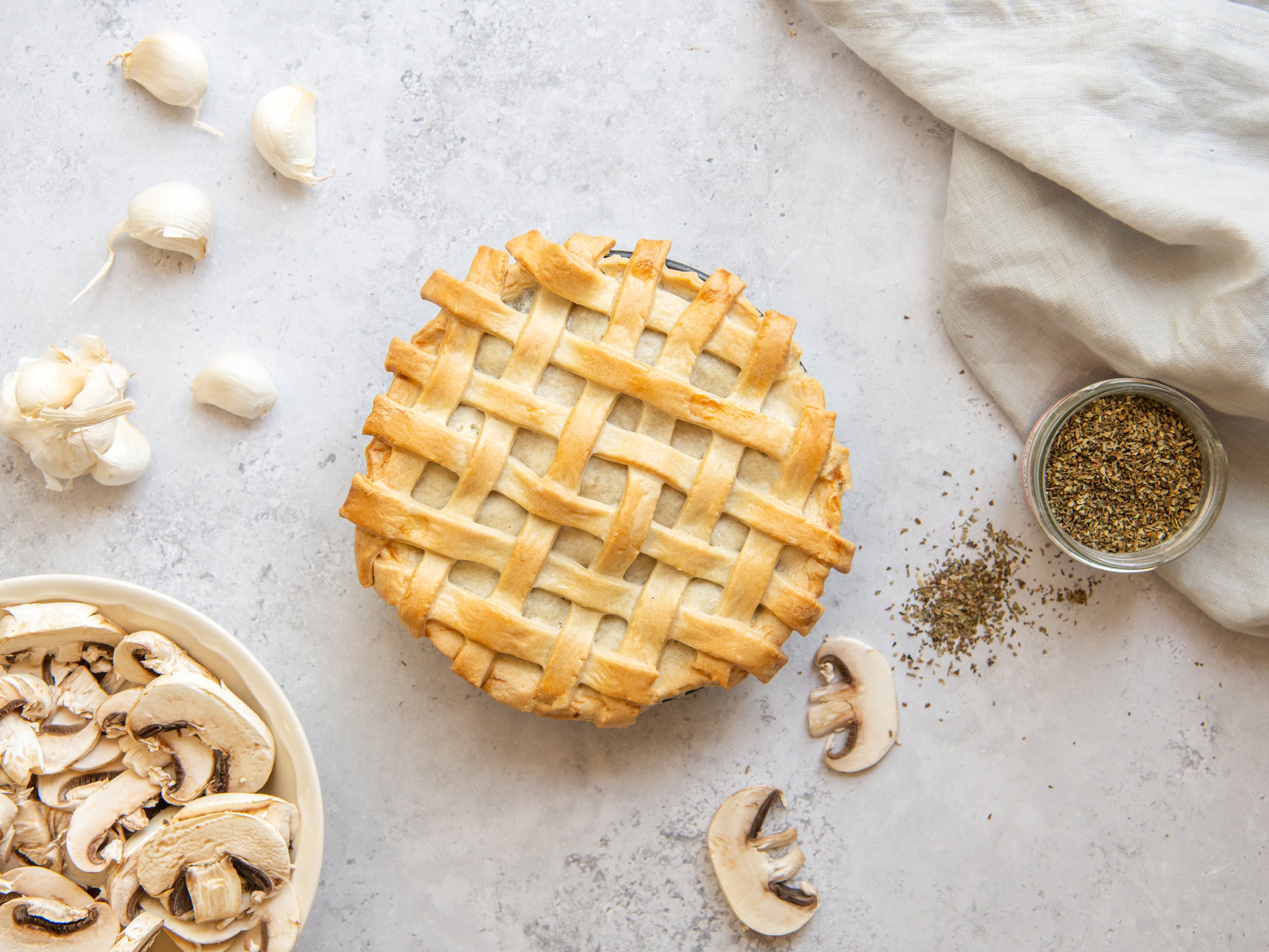 Top view of a traditional steak pie covered with latticed pastry 