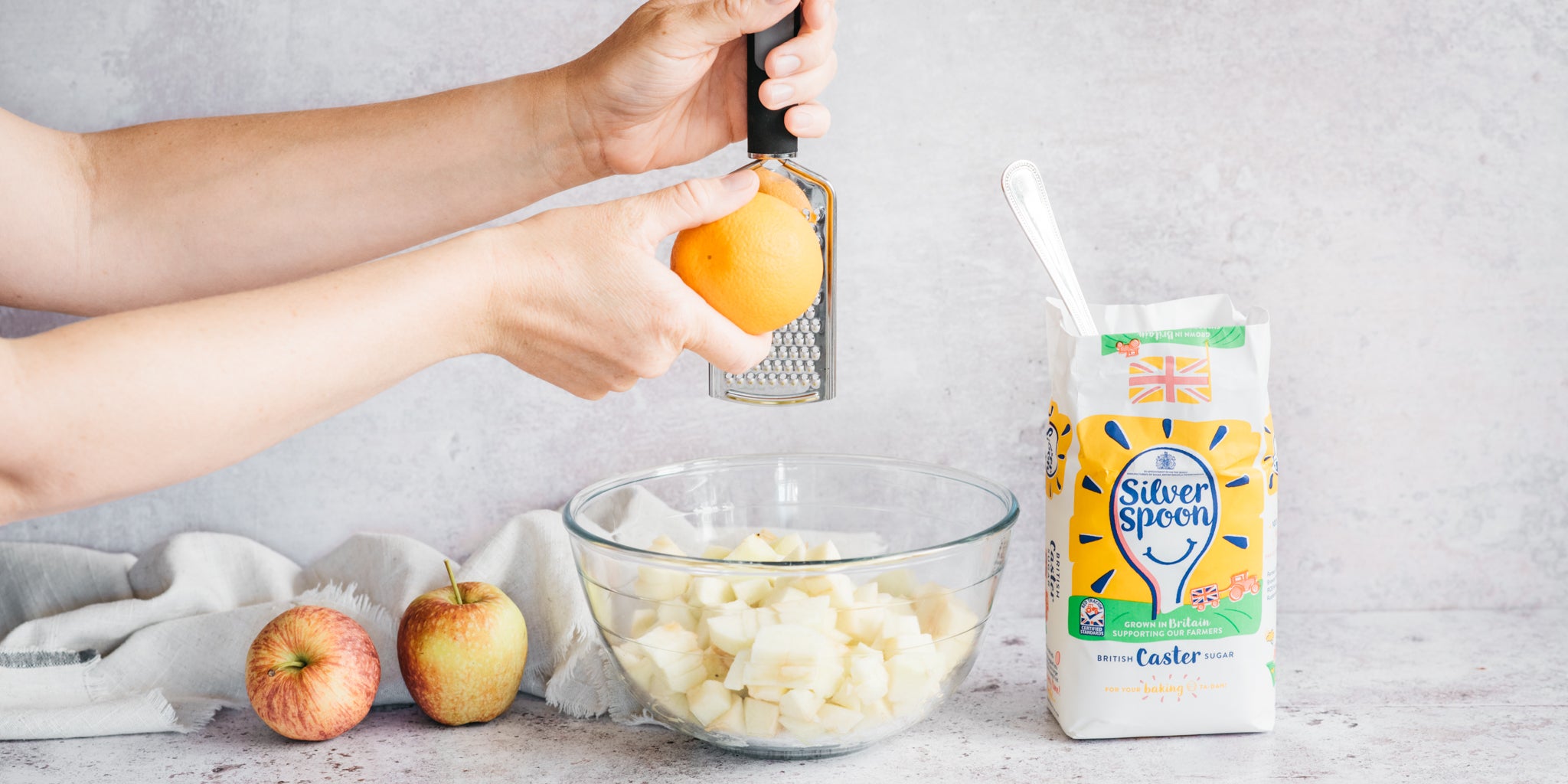 Hand grating apple into a bowl