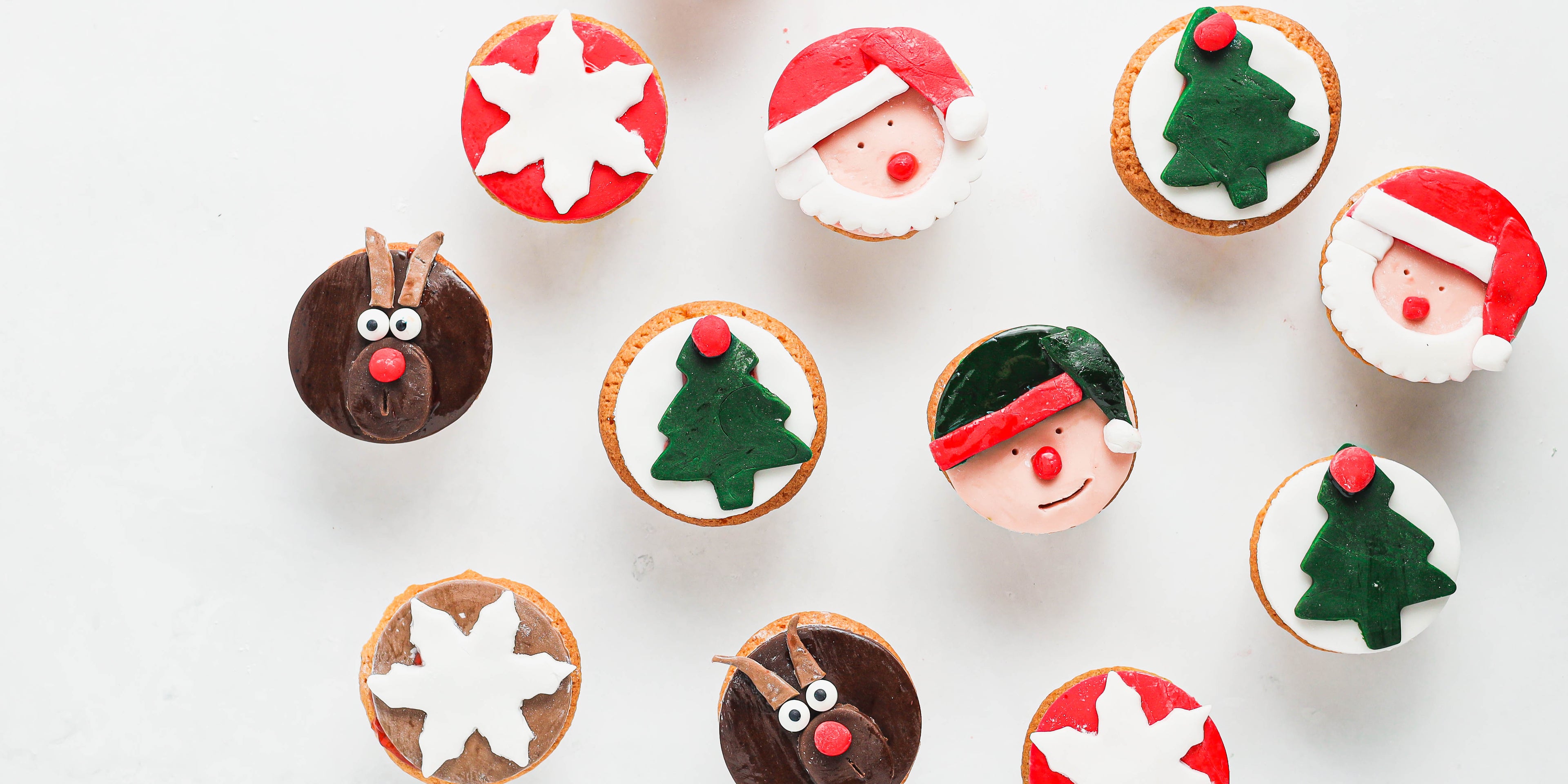Top view of Christmas Cupcakes decorated in icing with santa, reindeers and stars