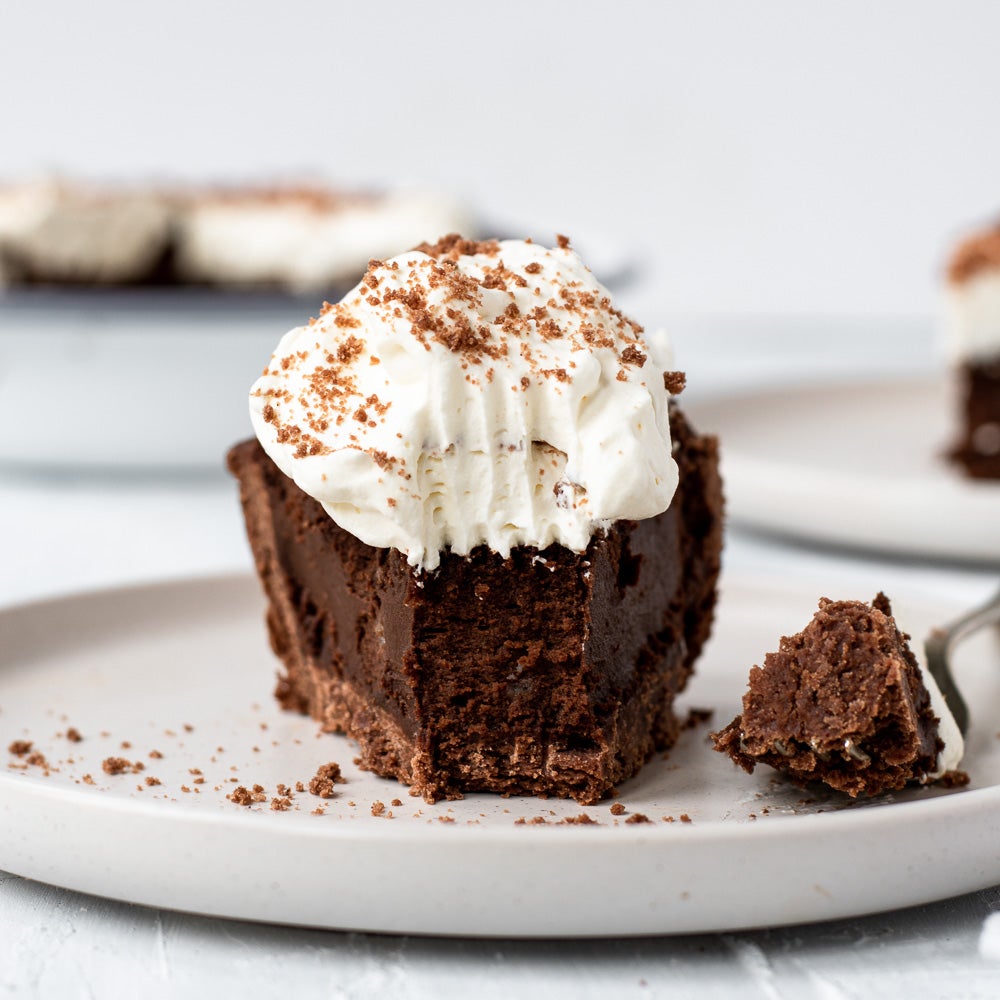 Slice of Mississippi mud pie with bite taken out on a plate