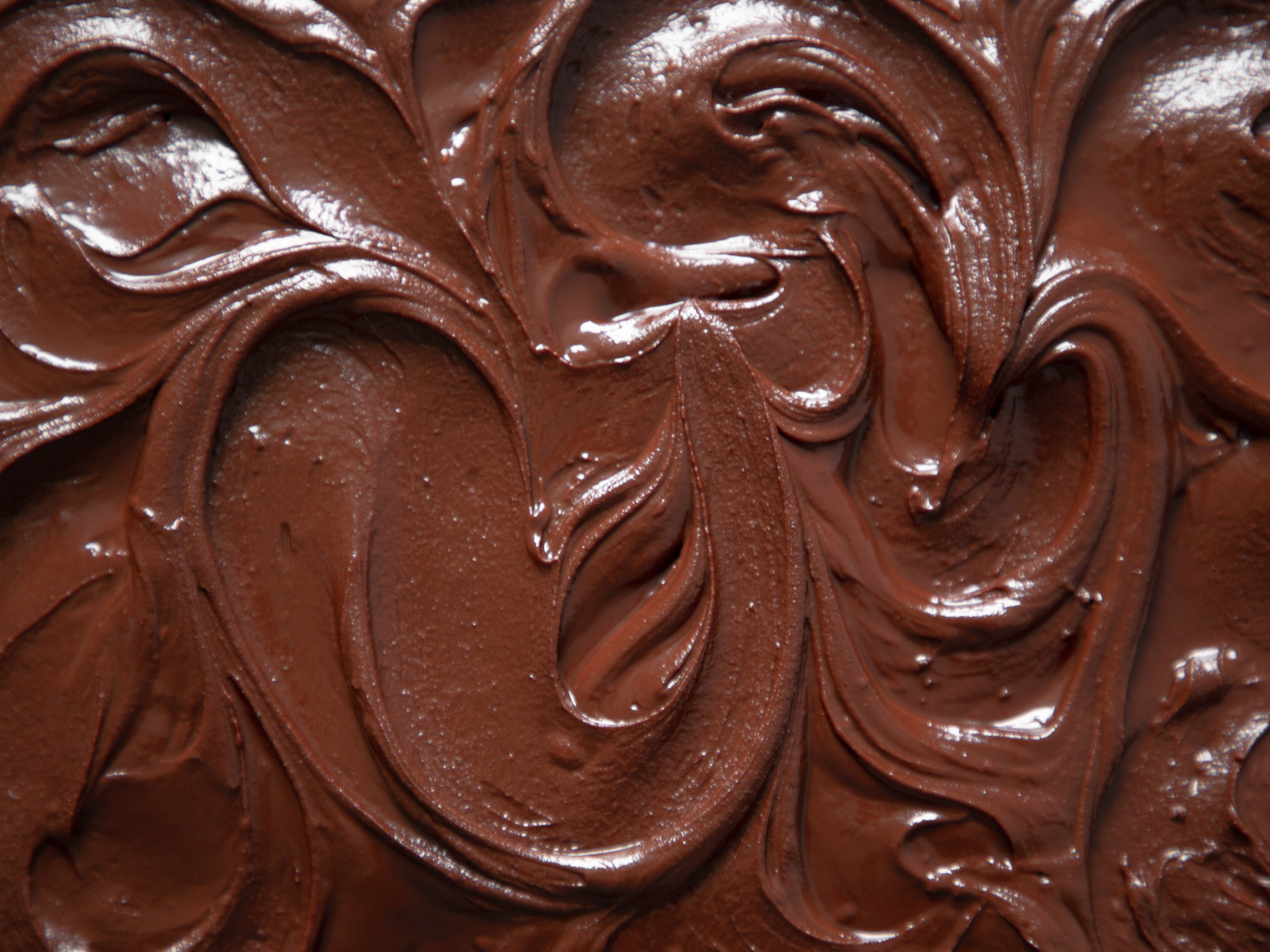 Close up showing of chocolate fudge icing, with swirls decoration