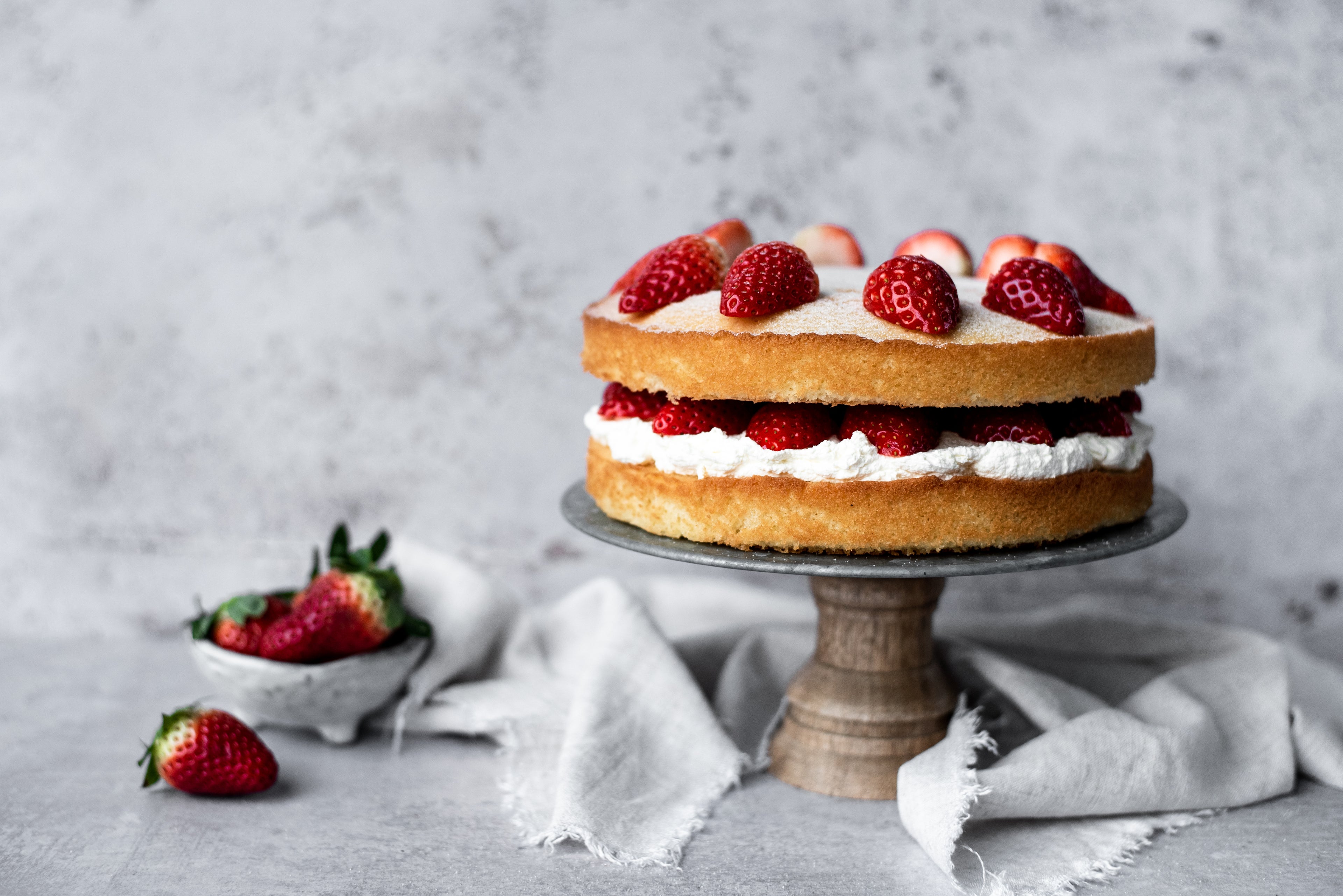 strawberries on top of a sponge cake