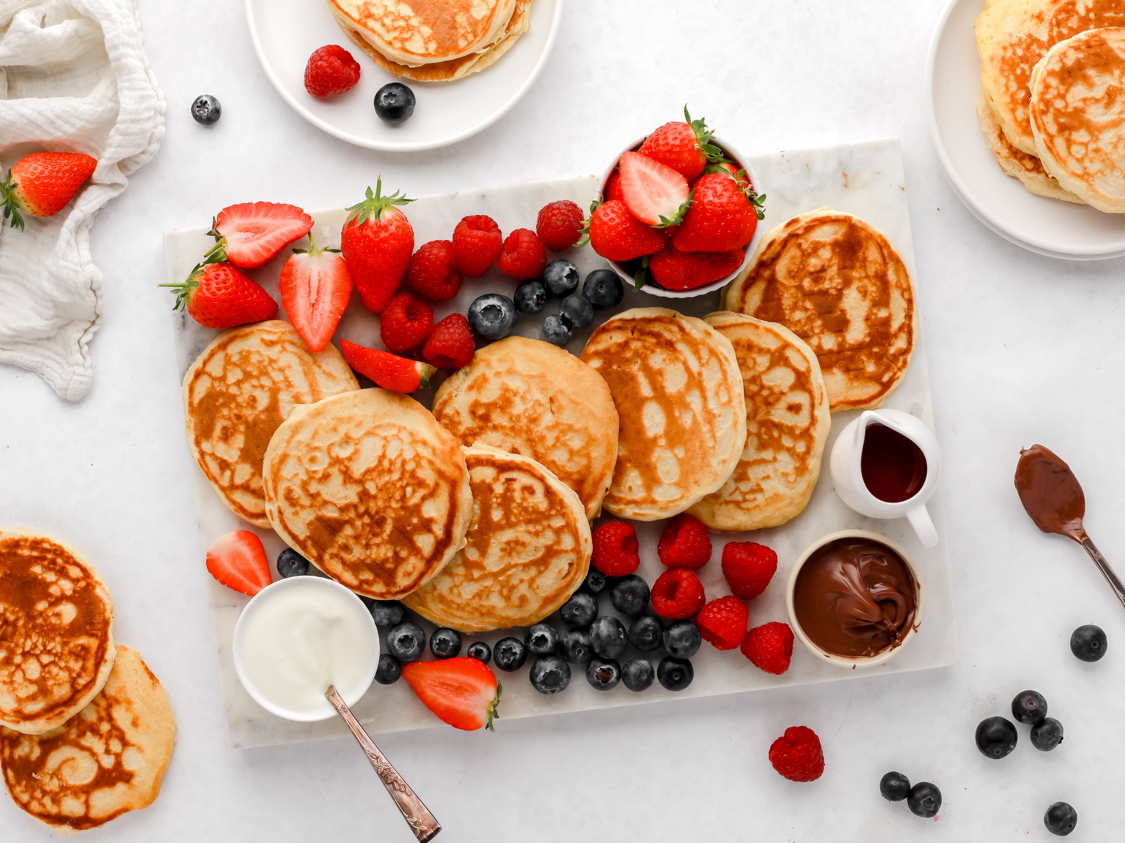 Pancake platter with fresh fruit and dipping bowls