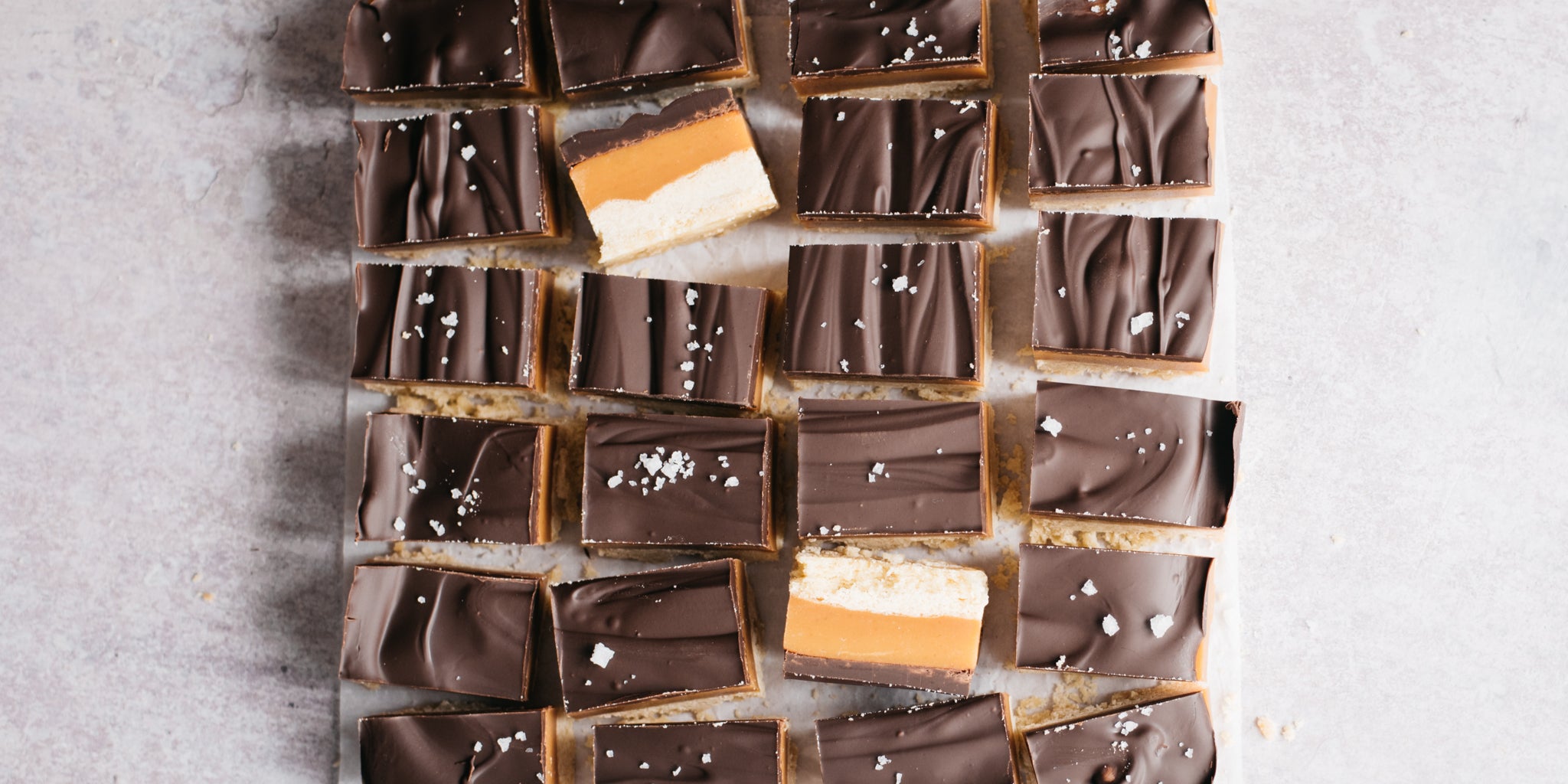 Squares of millionaires shortbread lined up 