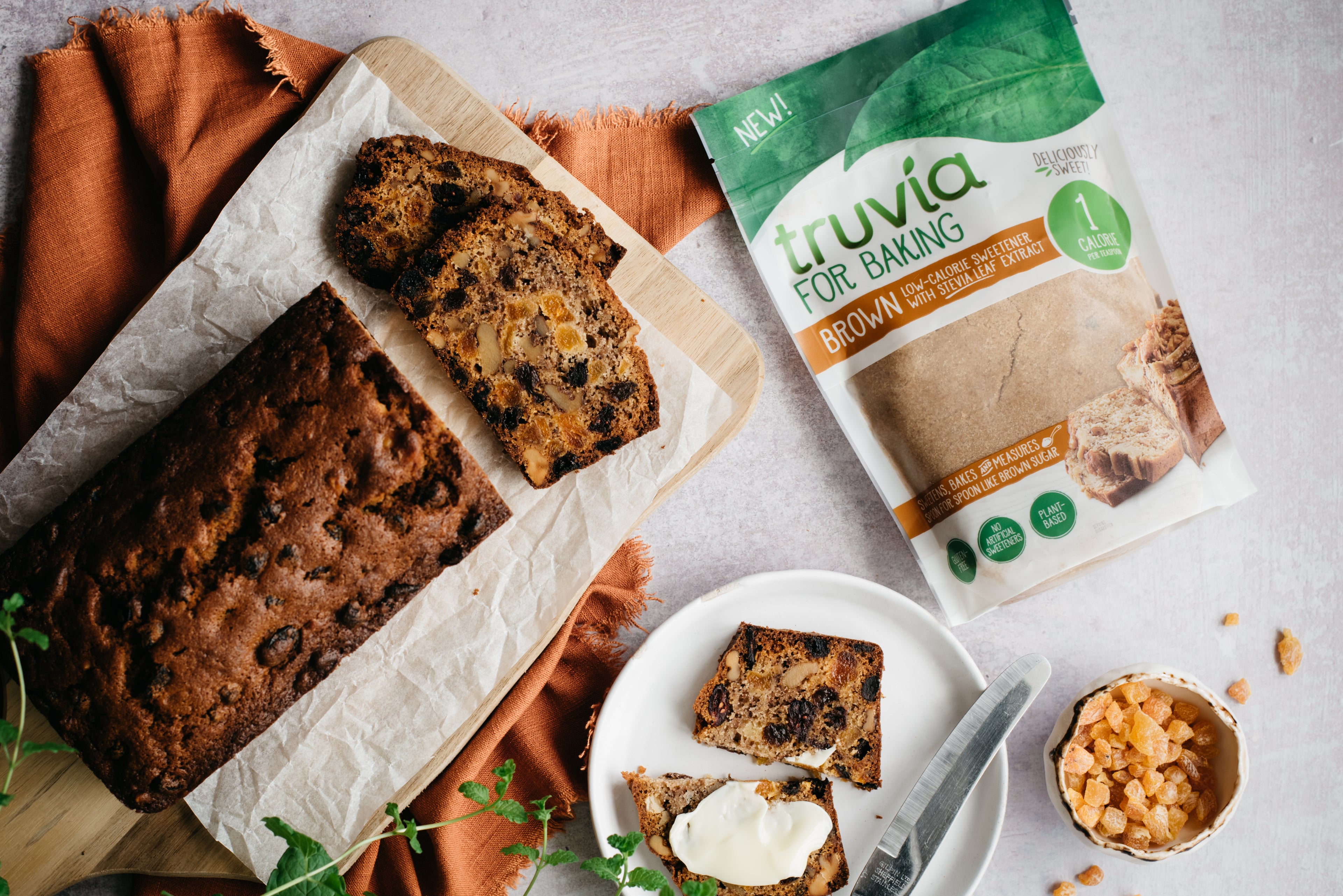 Light fruit cake next to a packet of truvia for baking brown