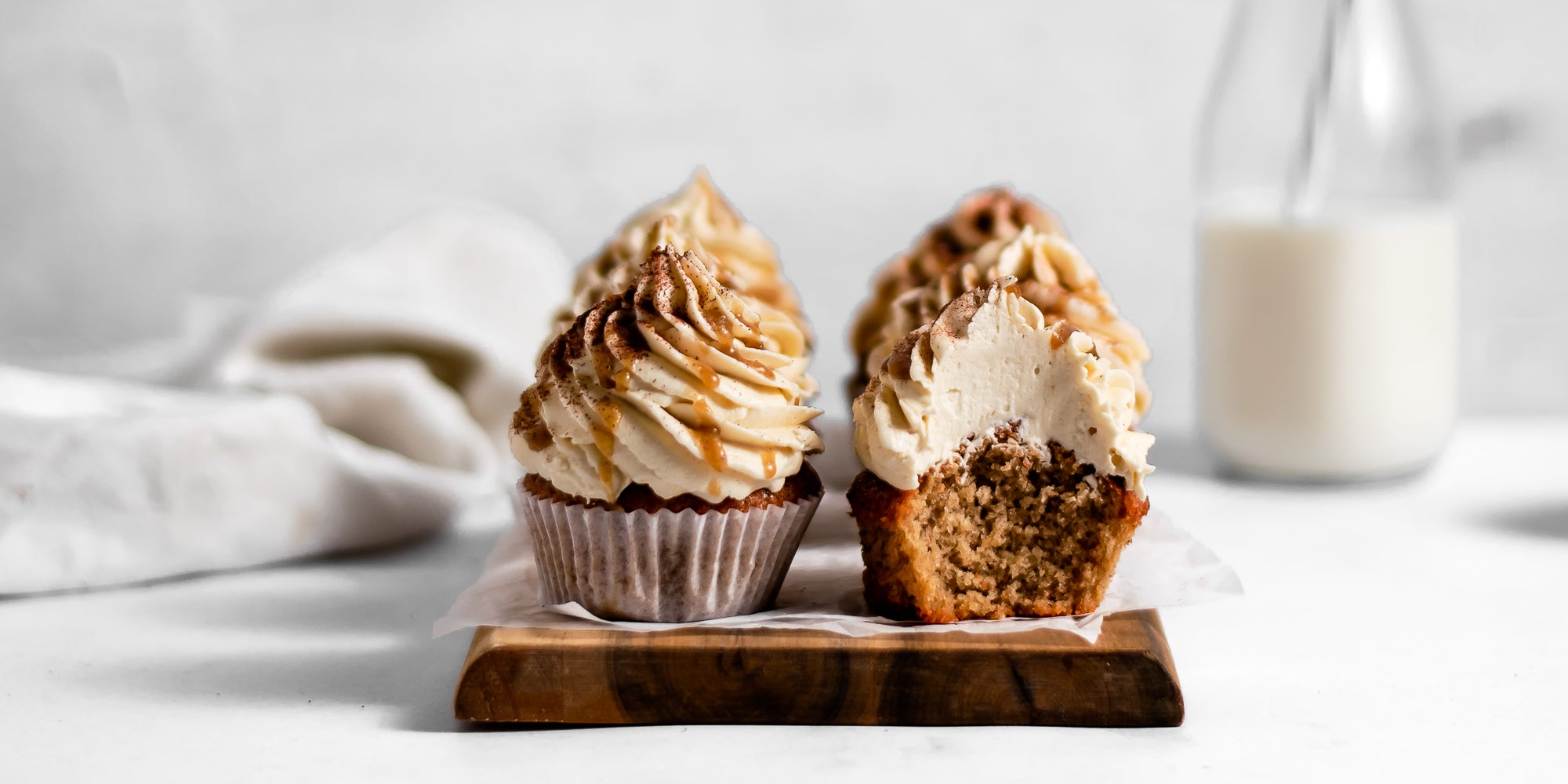 Close up of Gingerbread Cinnamon Cupcakes with a bite taken out of one, showing the yummy insides. 