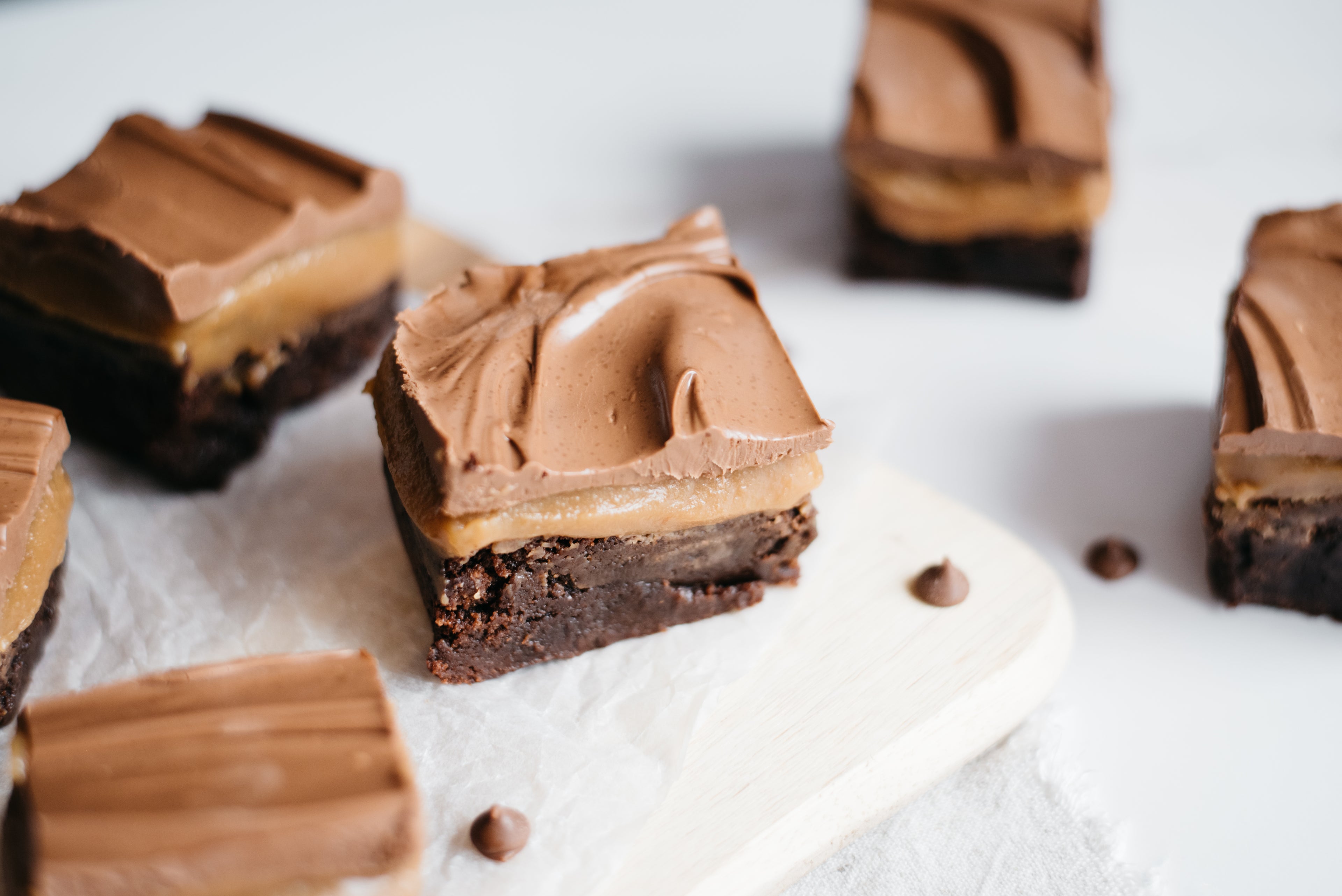 Close up on Brownie Based Millionaires Traybake with chocolate chips