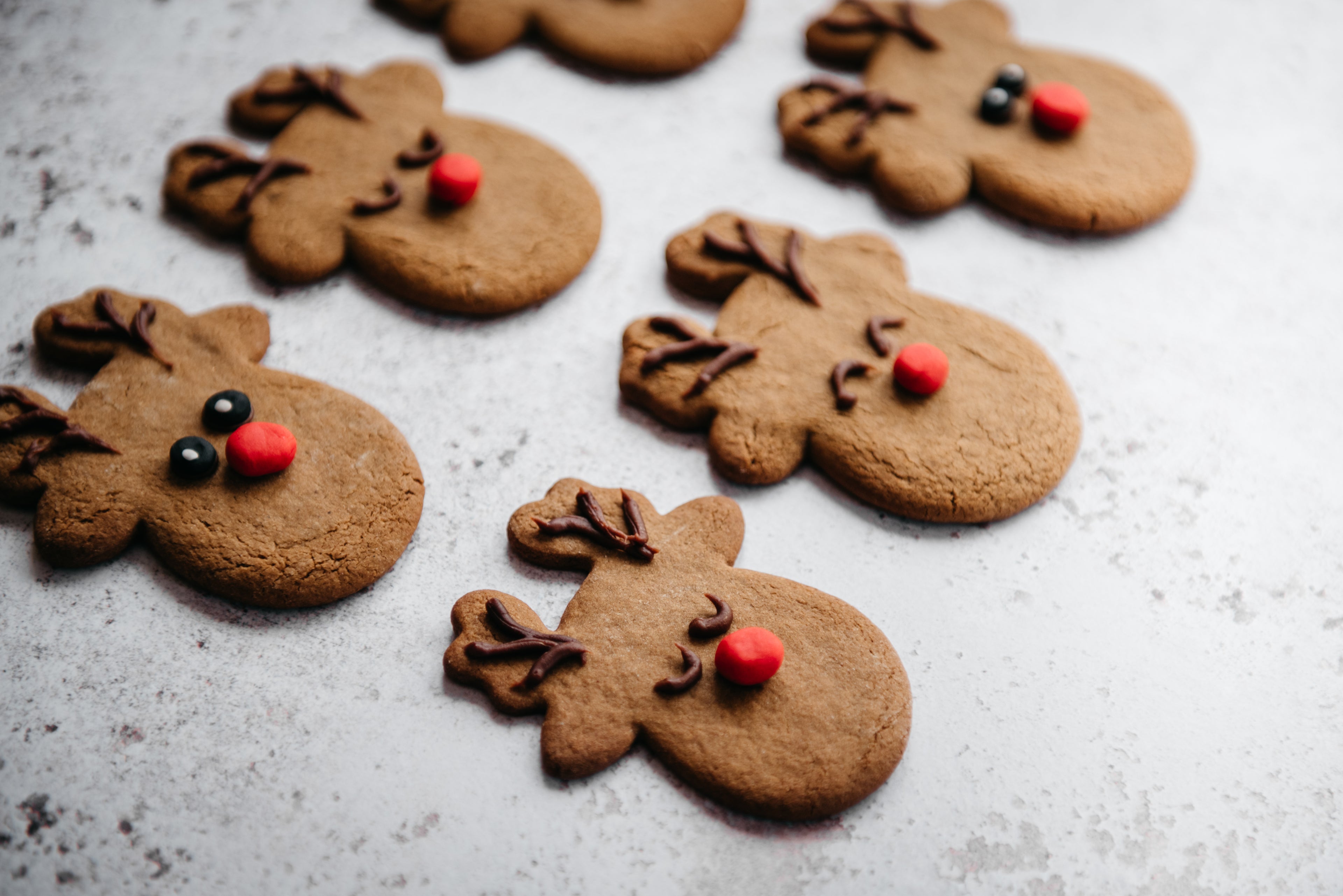 Close up of Reindeer Cookies, hand decorated with antlers, faces and red noses