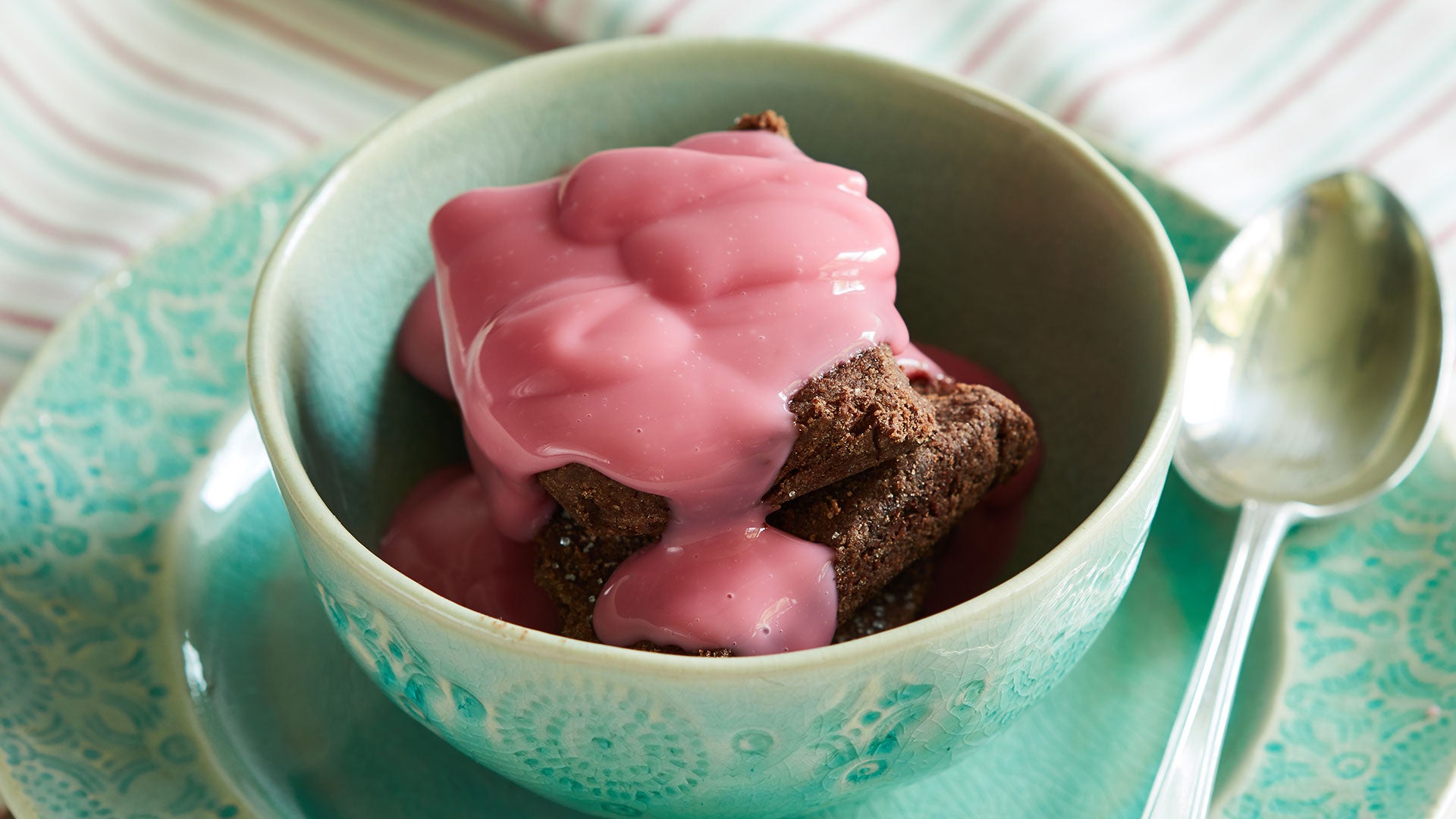 Chocolate brownie topped with thick pink custard
