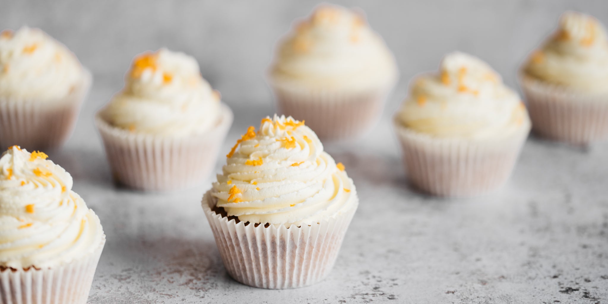 Close up of Orange Blossom Cupcakes sprinkled with fresh orange zest