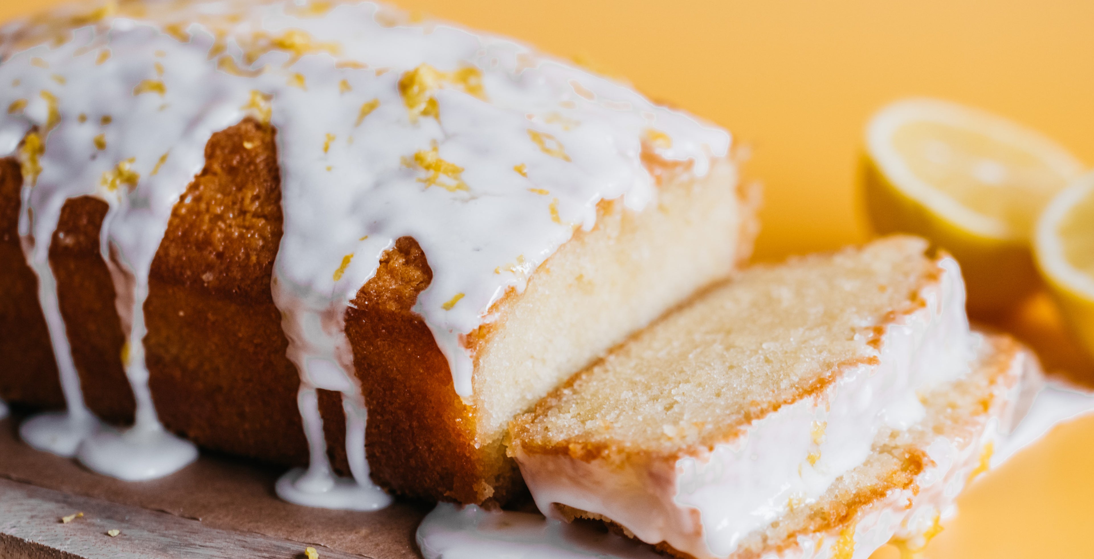 Homemade lemon drizzle cake with white lemon-flavoured icing drizzled over the top