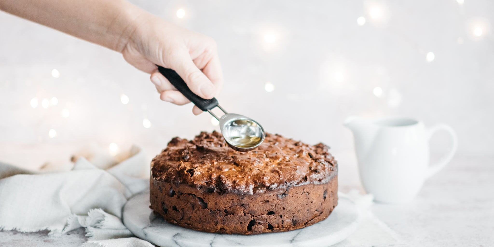 Feeding a Christmas cake with alcohol 