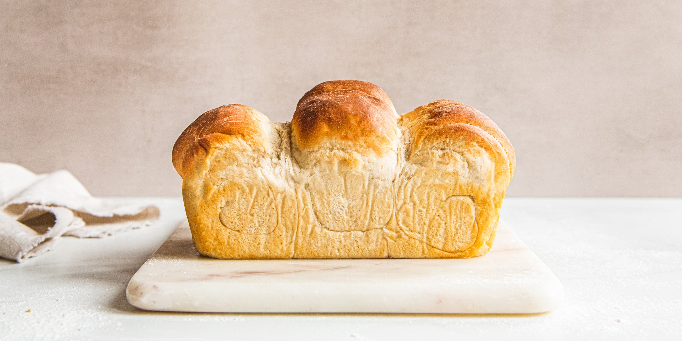 Shokupan Milk Bread side view, served on a marble board 