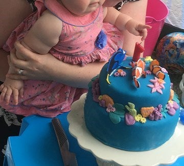 girl with blue birthday cake