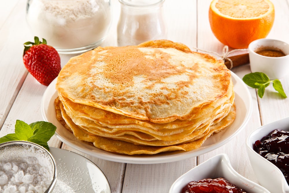 Stack of Russian pancakes on a white plate