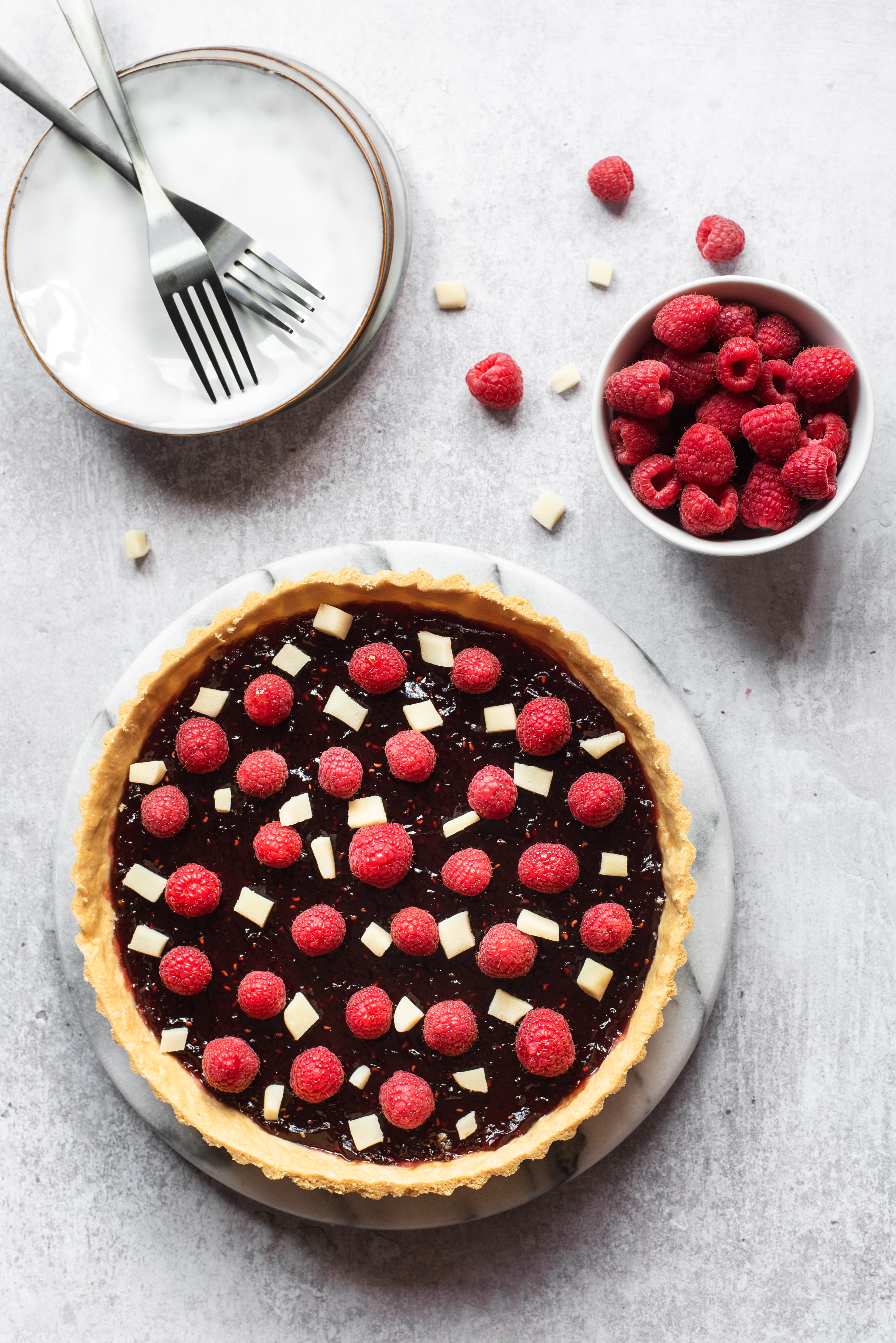 birds-eye view of a sweet tart topped with raspberries