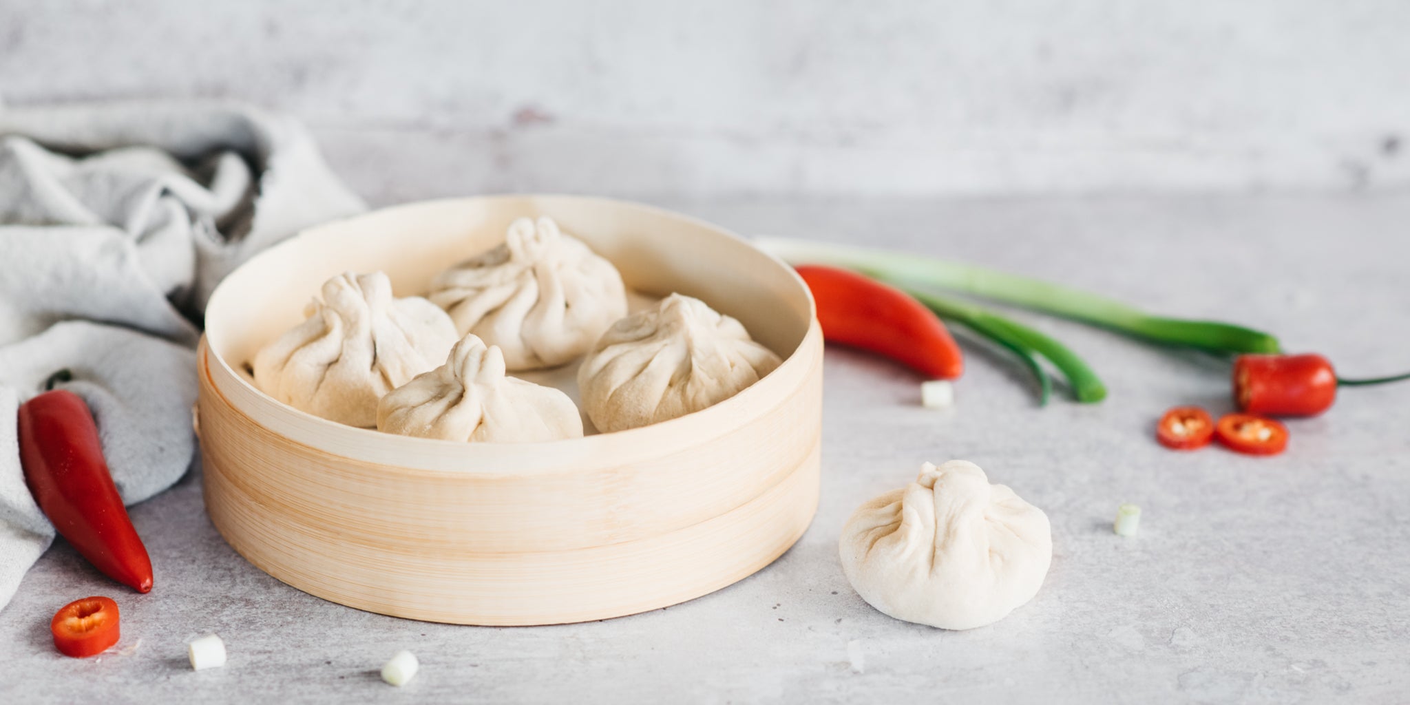 Bao buns positioned in a circular steamer