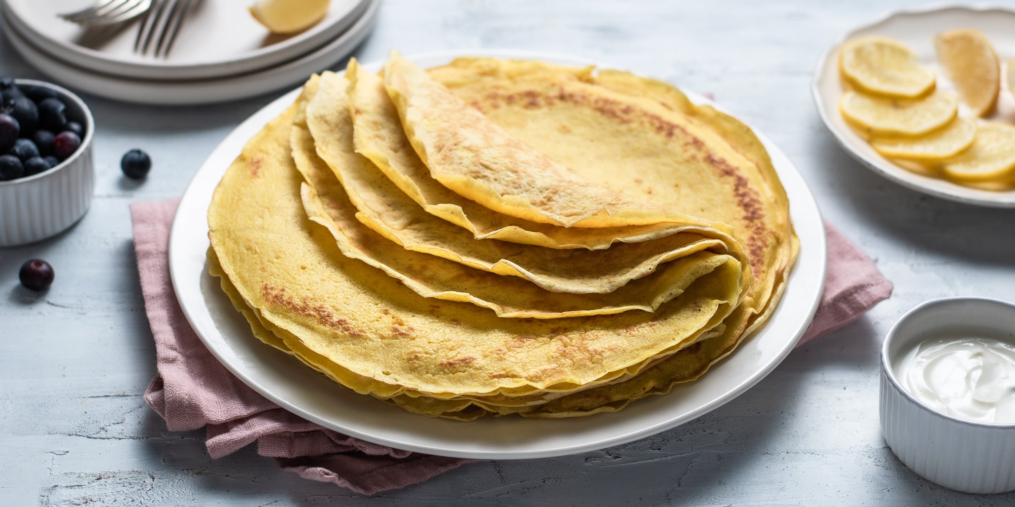 A close up view of turmeric and lemon pancakes on a plate