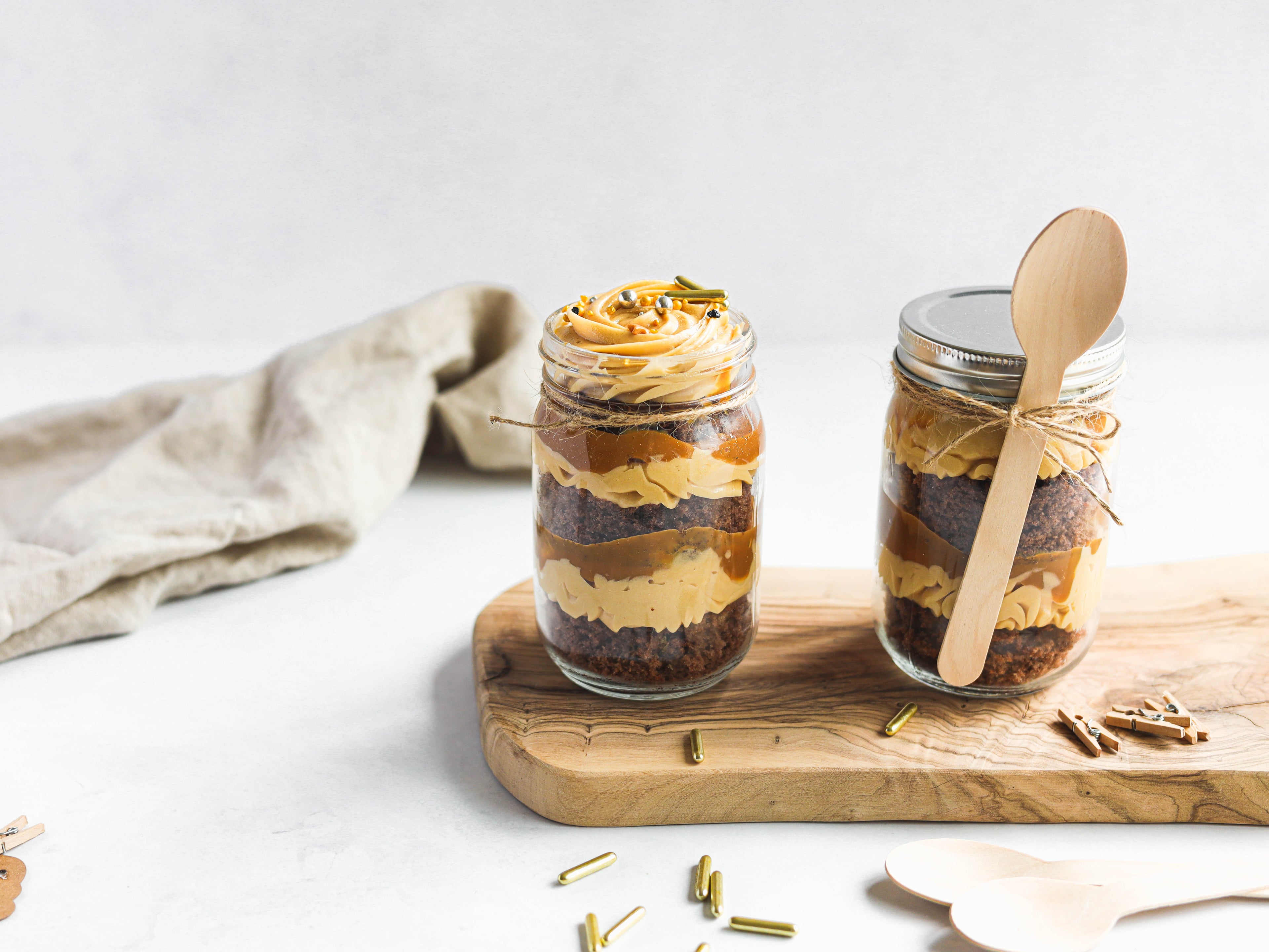 Caramel Cake in a Jar hand tied with a wooden spoon and sprinkles